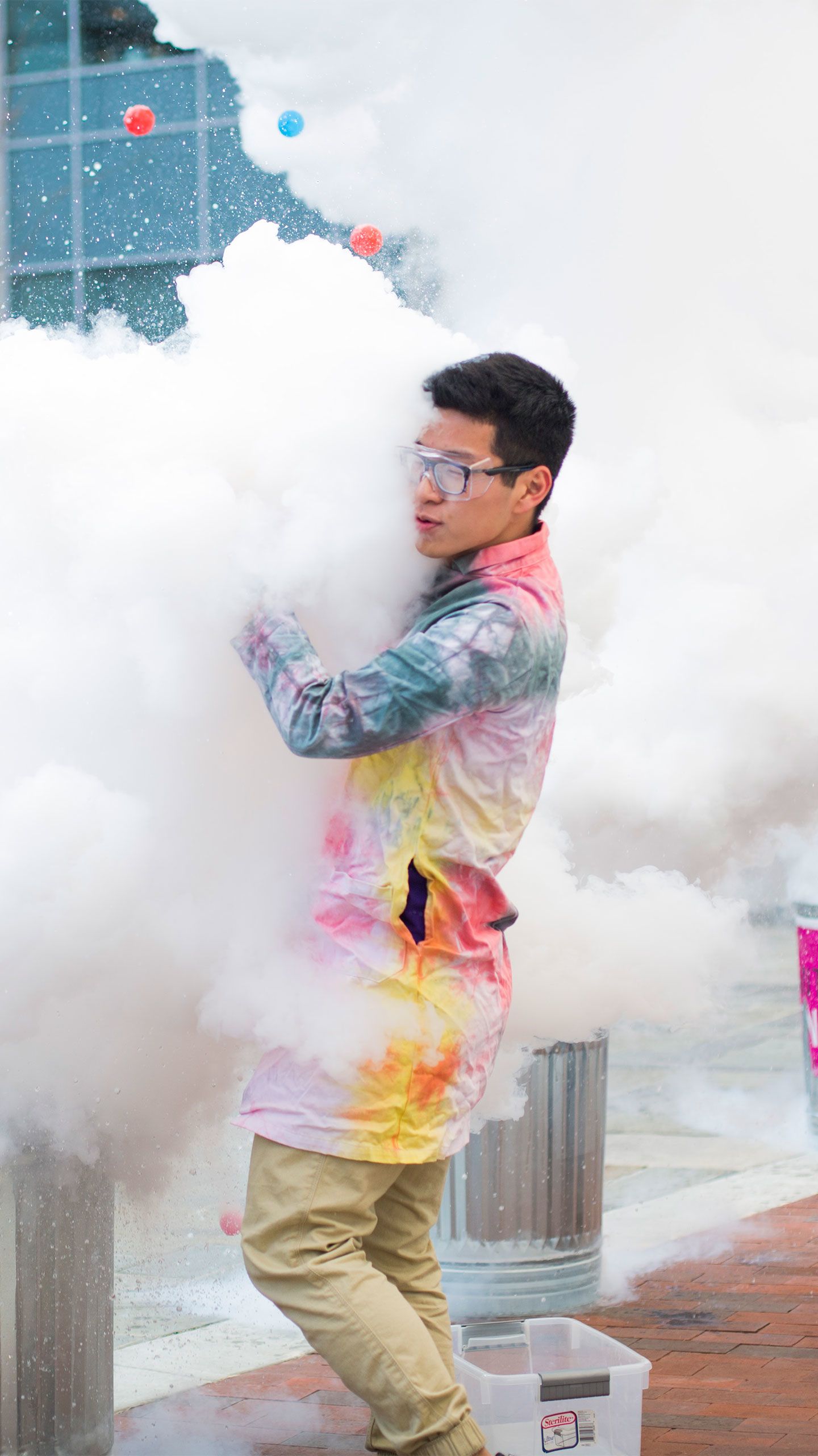 Giant clouds of white rise up from trash cans as they pour the liquid in.