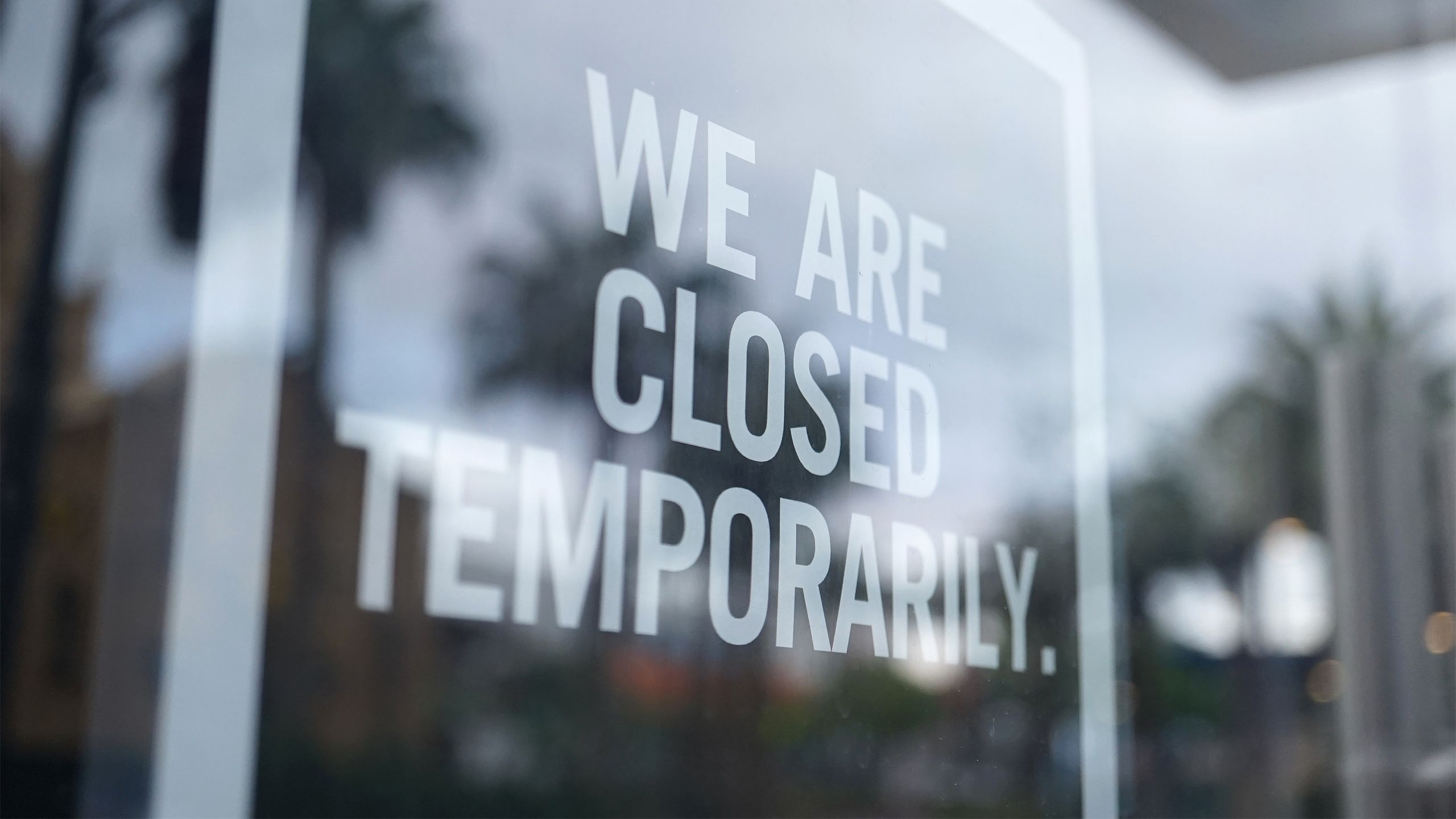 A business with "we are closed temporarily" on the window