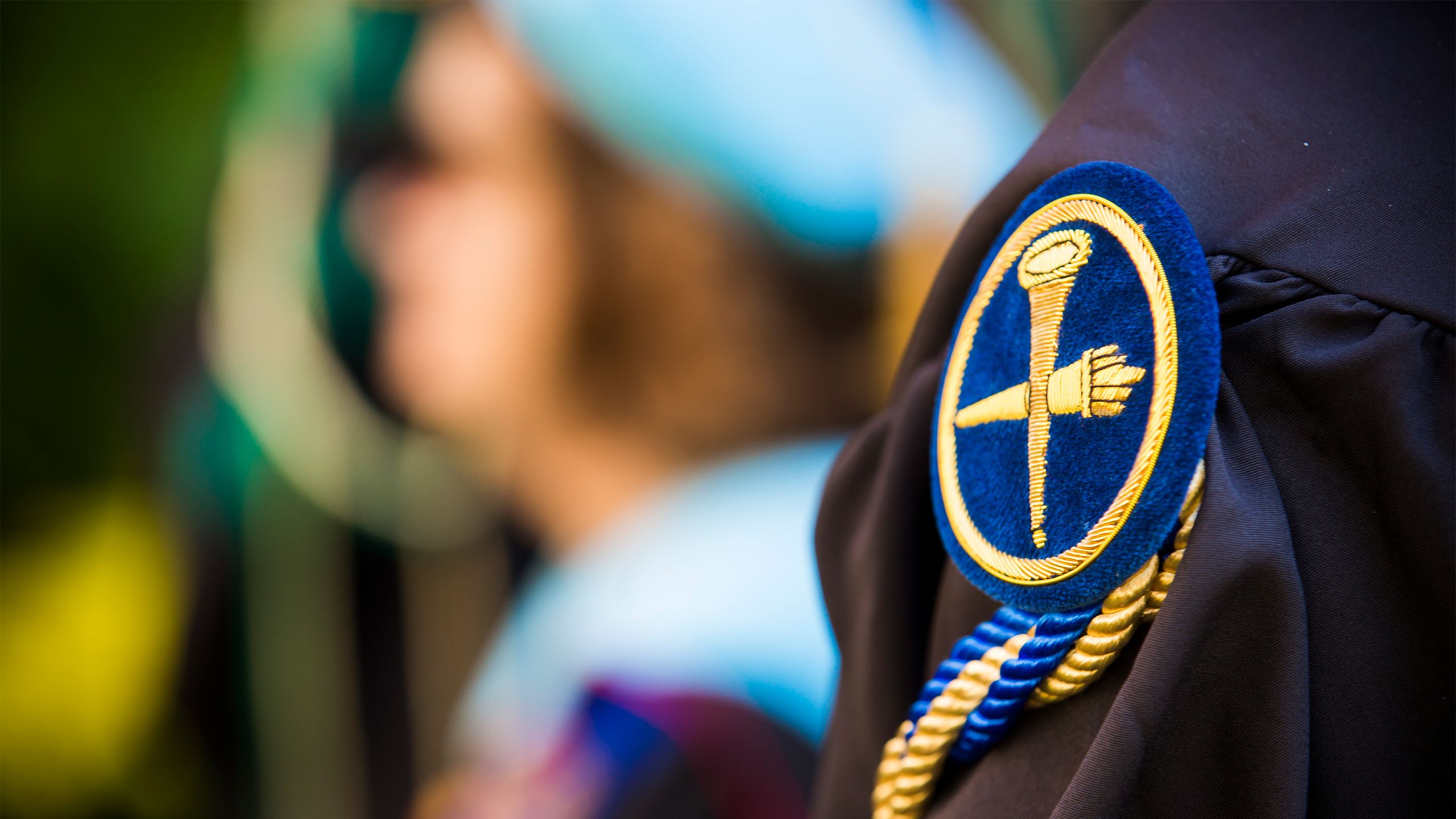 A close-up photo of the Emory emblem on a Commencement gown