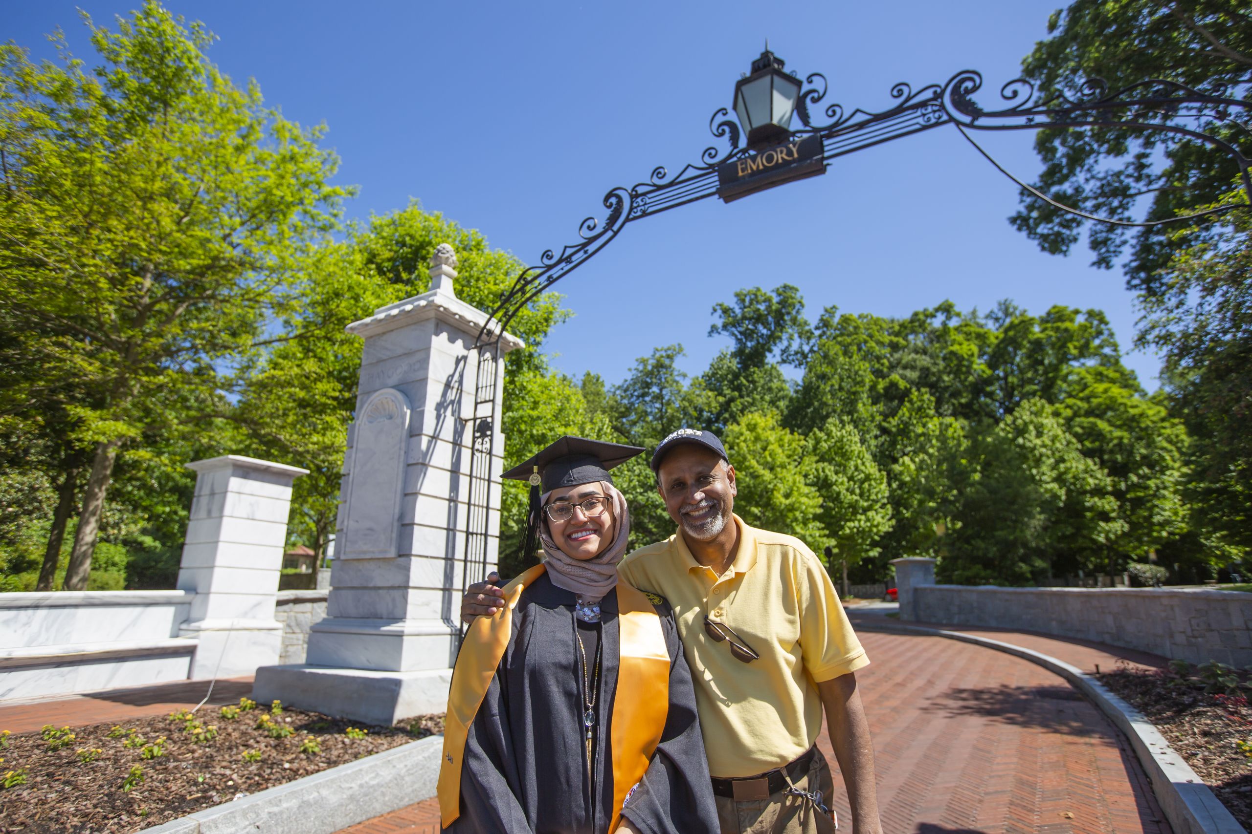 A student hugs a relative in front of the Emory gate