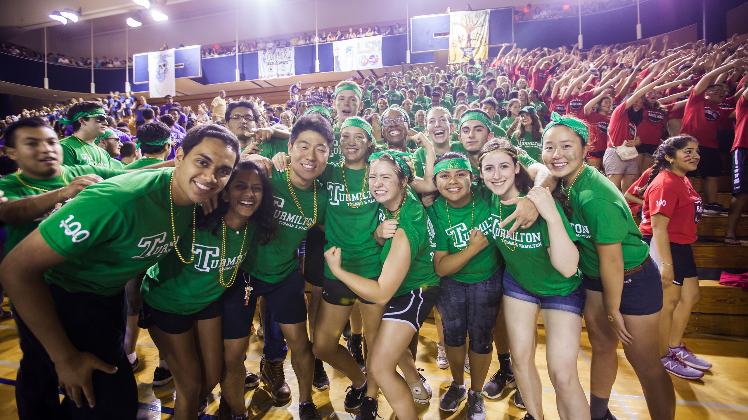 Students wearing matching shirts singing