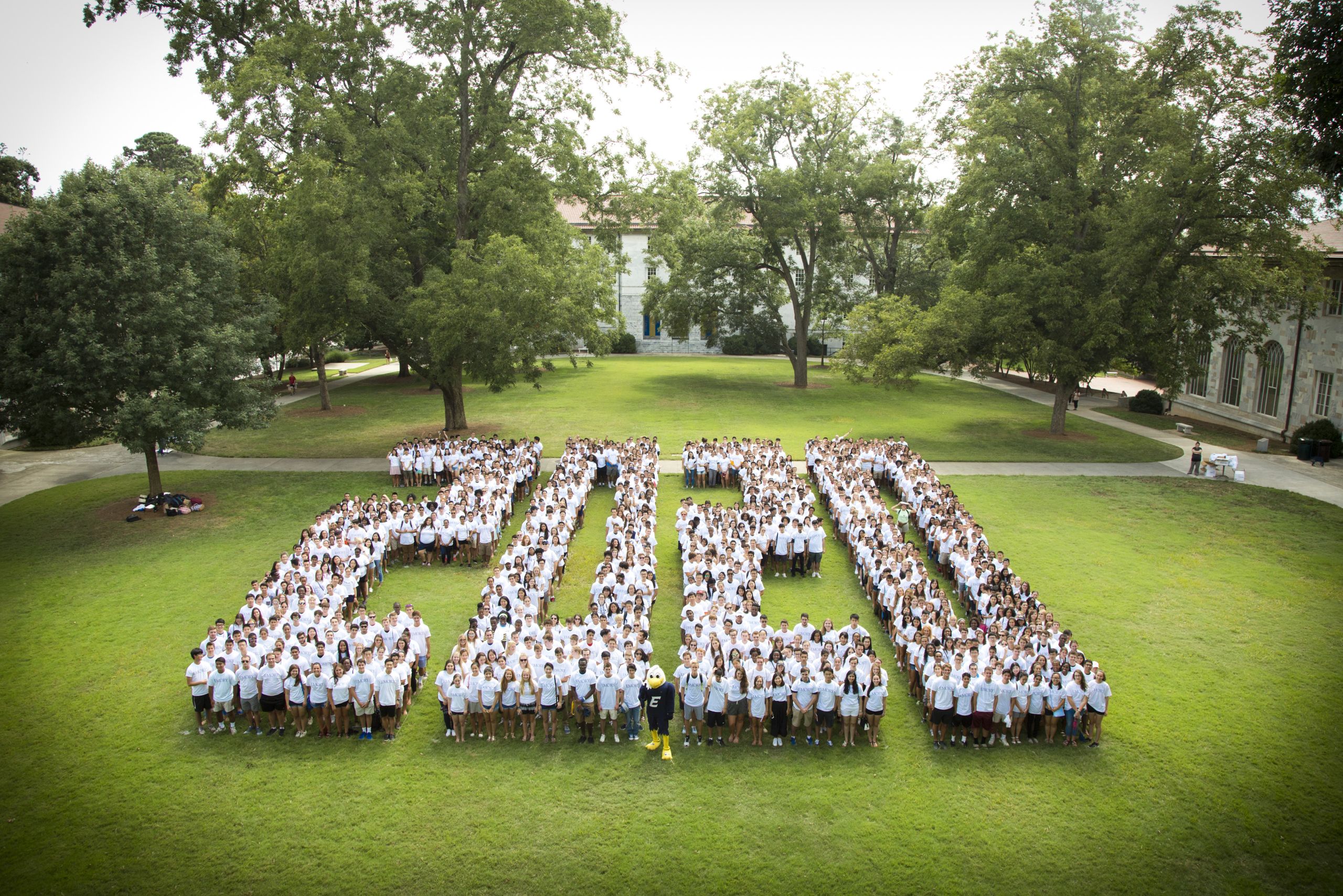 Wearing white shirts, students pose in the shape of the number 2020