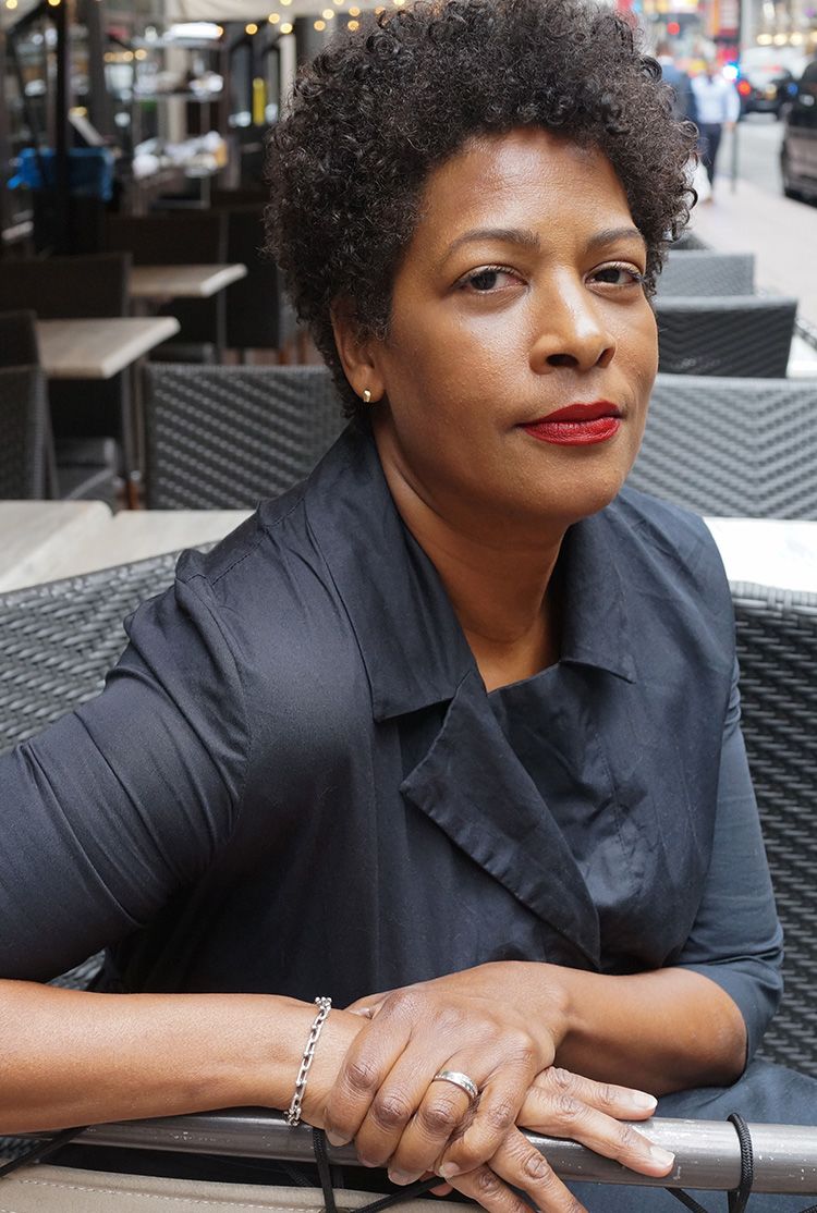Filmmaker Dawn Porter sitting in church pew listening to speak