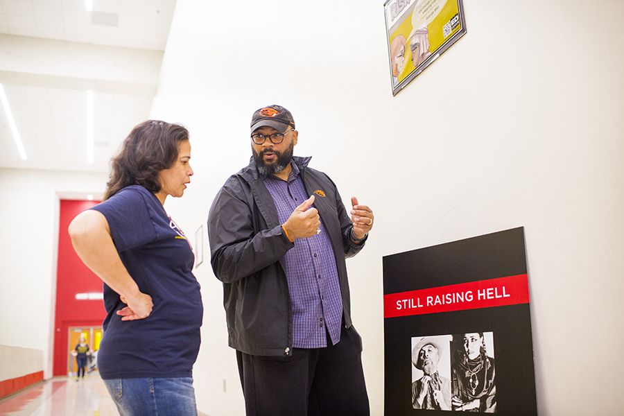 Photo of McDaniels and Barbara Coble, Emory Graduation Generation education partnerships manager, are shown installing part of the “Speak What Must Be Spoken” at MLK Jr. Middle School in Atlanta in 2019.