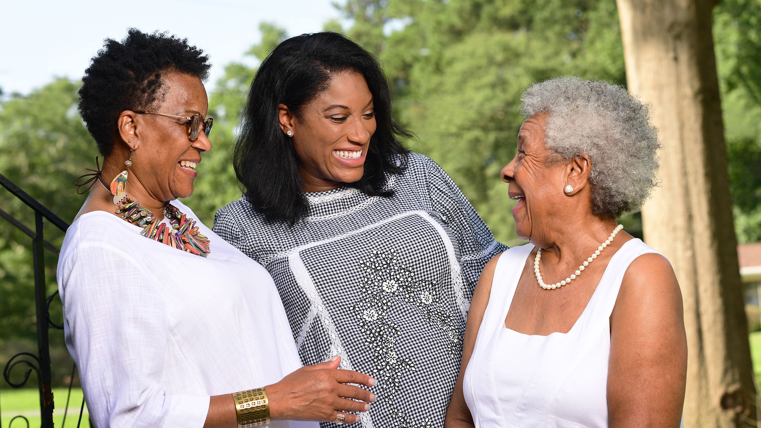 Barbara and Mikisha Johnson laugh with Elizabeth Matthews