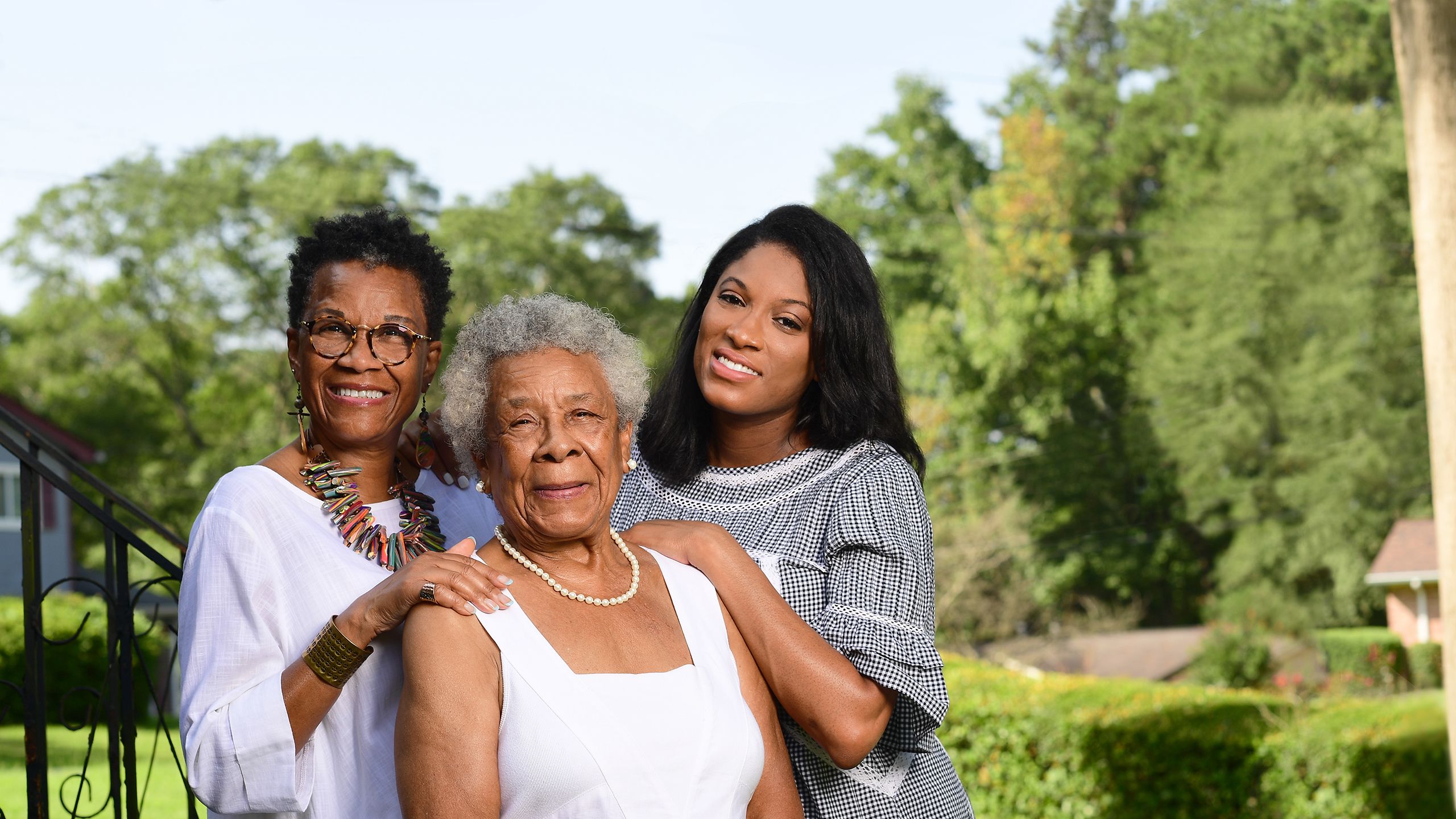 Barbara and Mikisha Johnson pose with Elizabeth Matthews