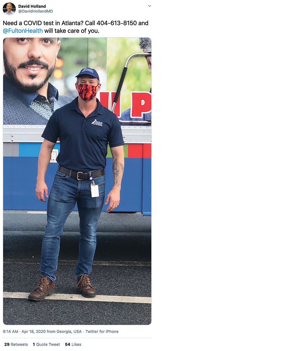 Man standing in front of a bus with a mask on.