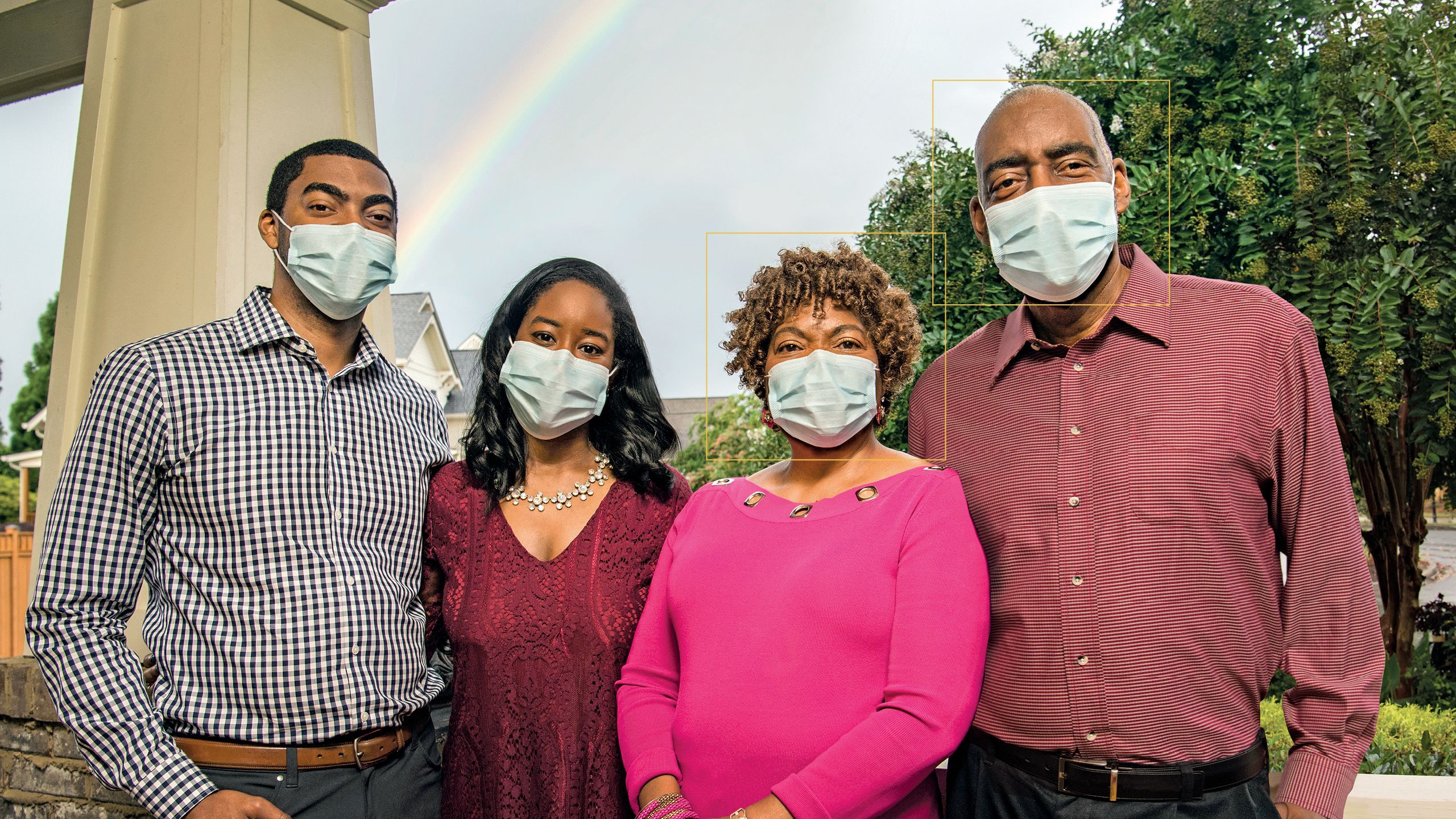 A group photo of a family, consisting of a son, daughter, mom and dad, outside their home.