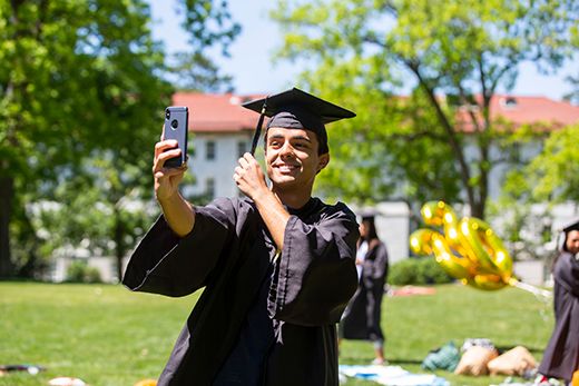 Emory Class 0f 2020 graduate taking selfie on Emory Quad