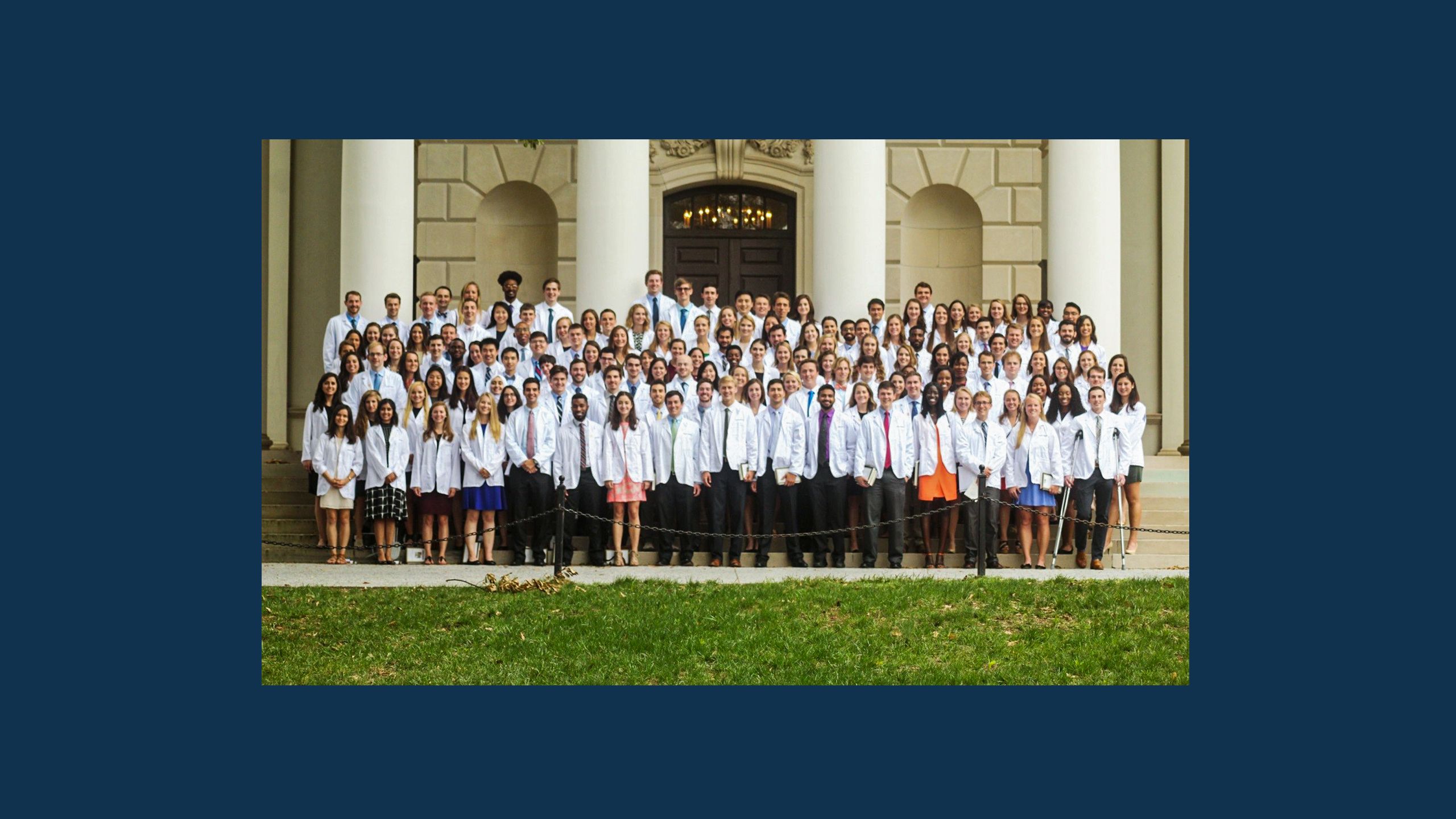 A group shot of six medical students in white coats. 