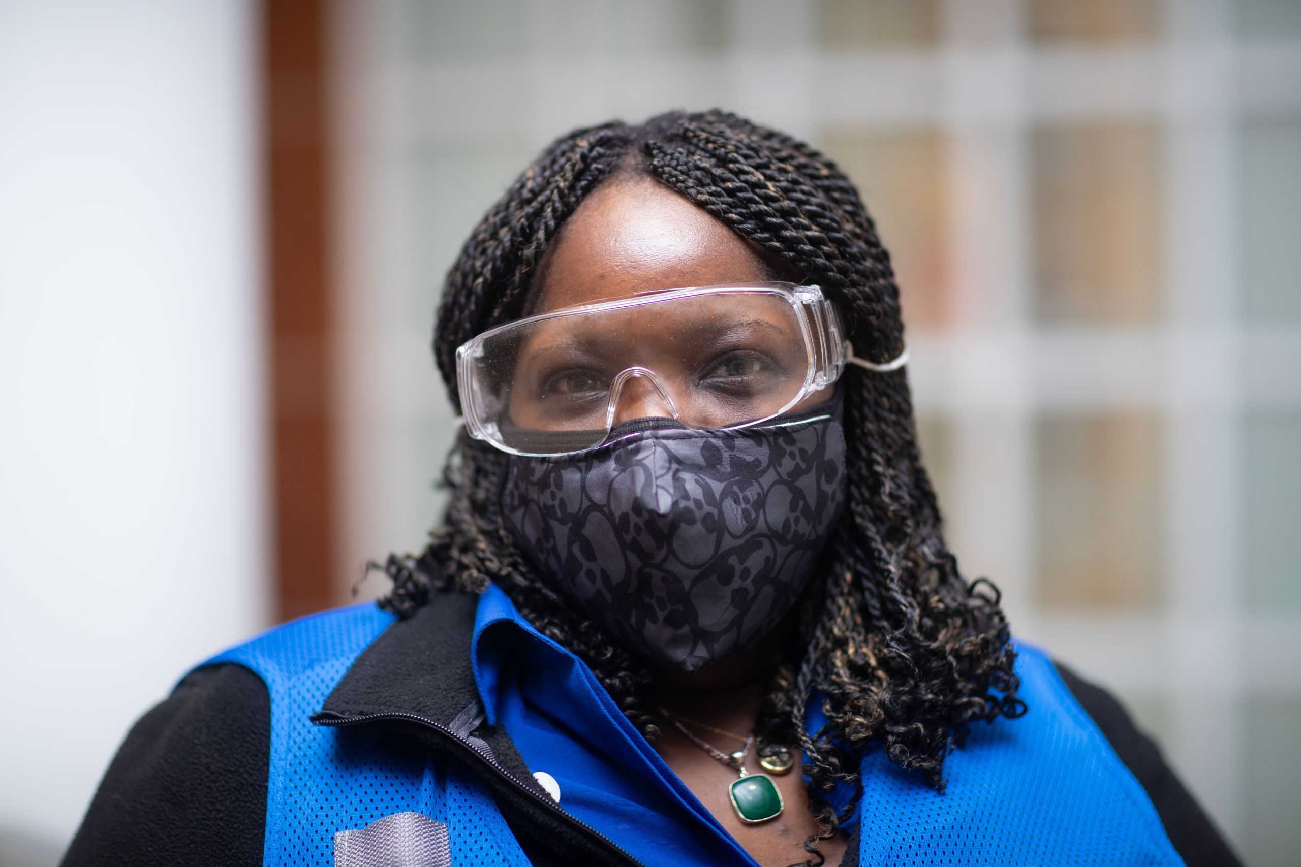 a volunteer wearing a vest and mask