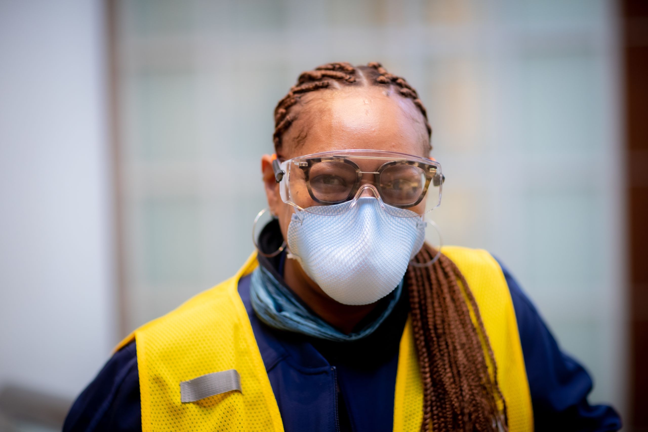 portrait of a volunteer wearing a vest and face covering
