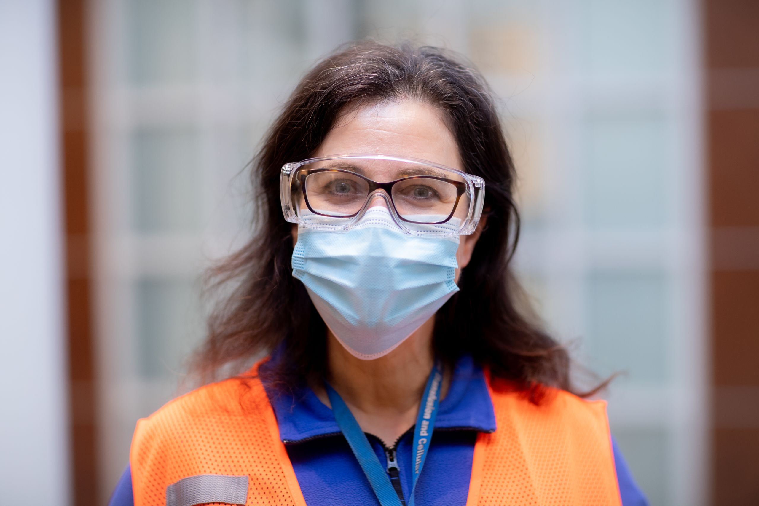 portrait of a volunteer wearing a vest and face covering