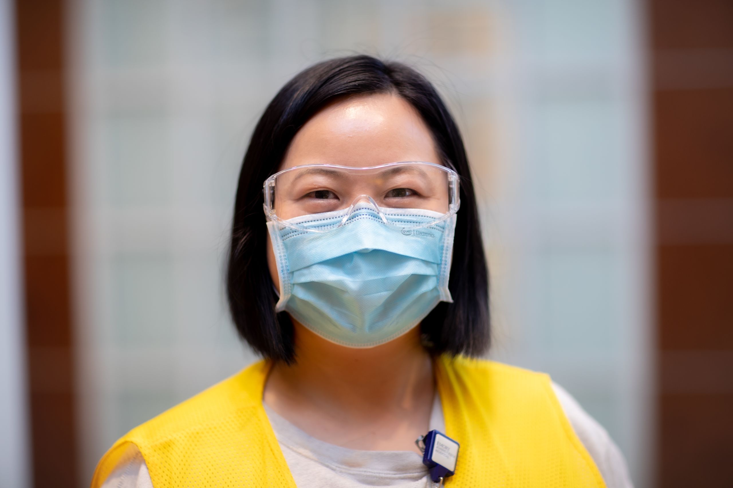 portrait of a volunteer wearing a vest and face covering