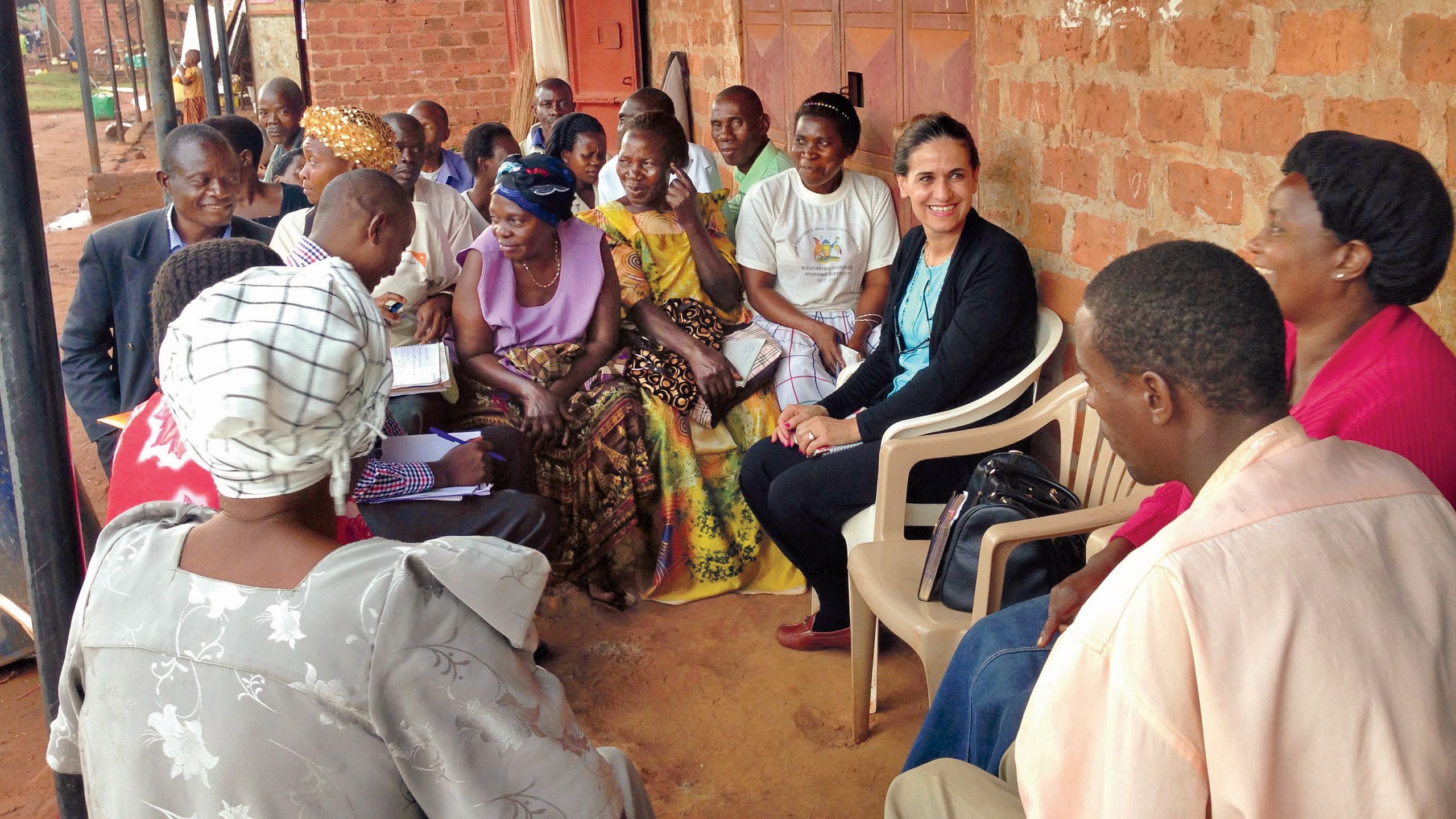 Taroub Harb Faramand talking with a group of people in Eastern Uganda.