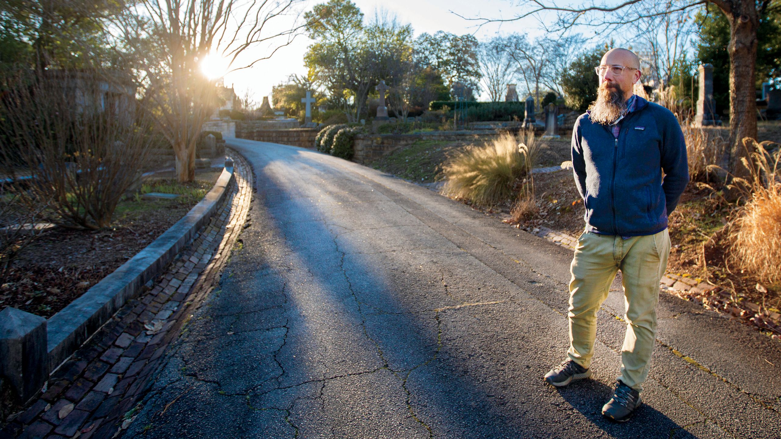 a photo of Michael Kramer standing in a slave square in atlanta's oakland cemetery.
