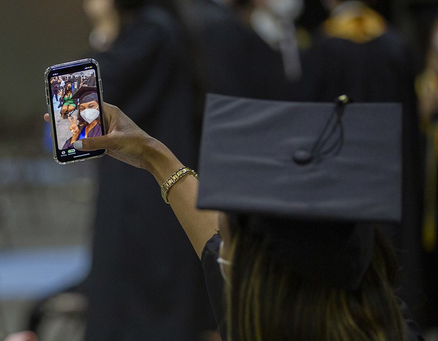 Graduate taking selfie