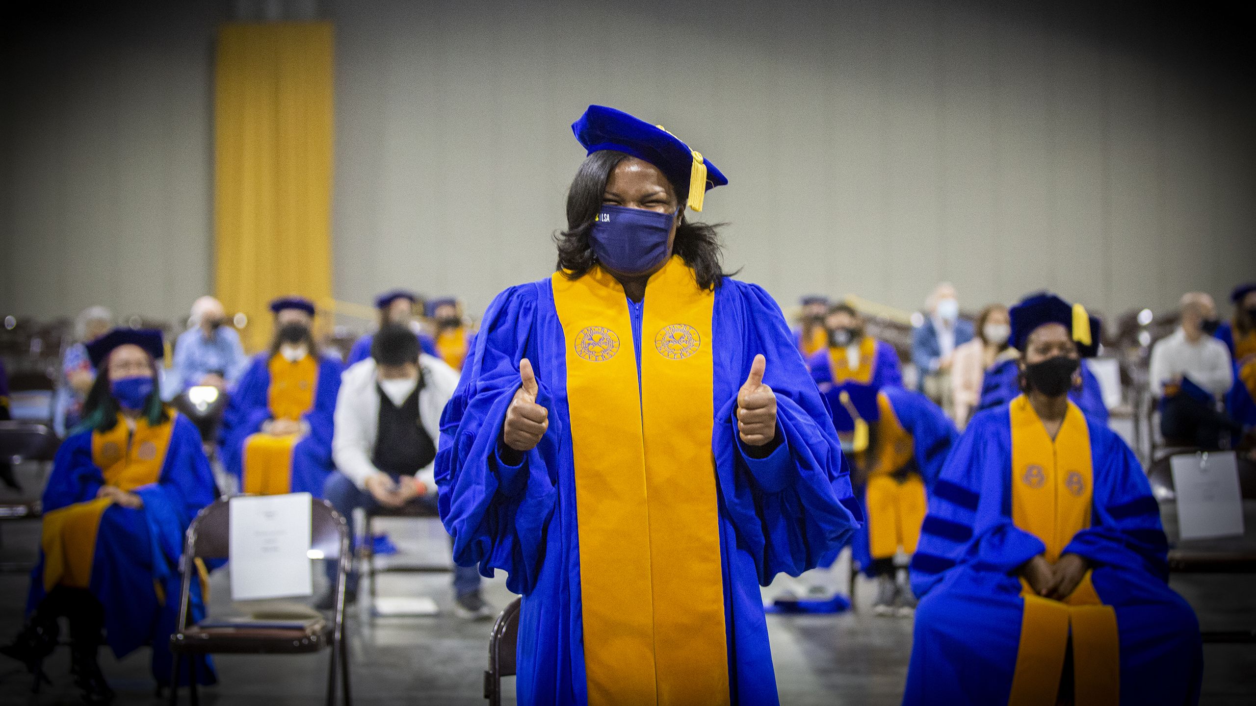 A graduate gives the thumbs up