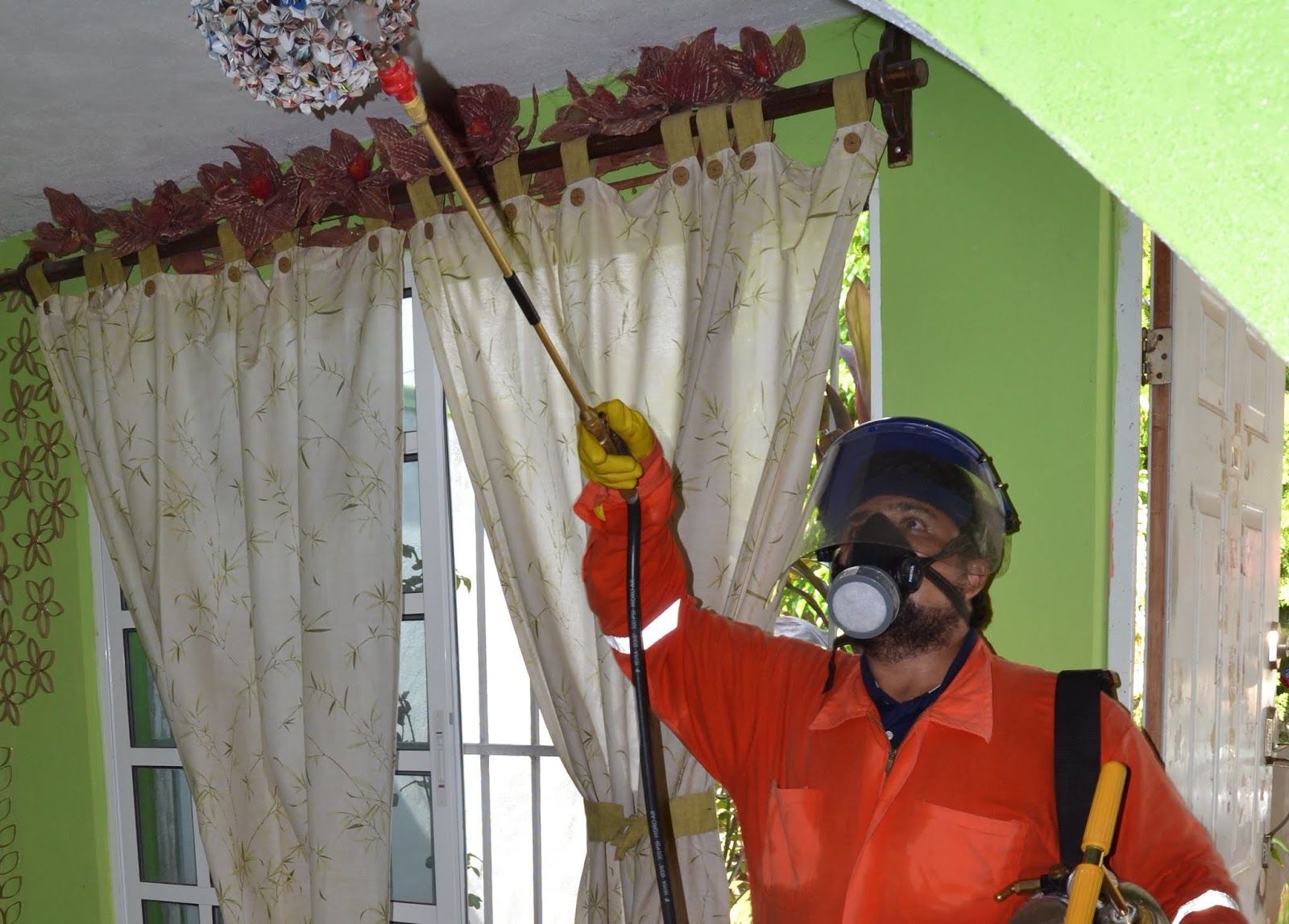 A technician treats a home with insecticide.