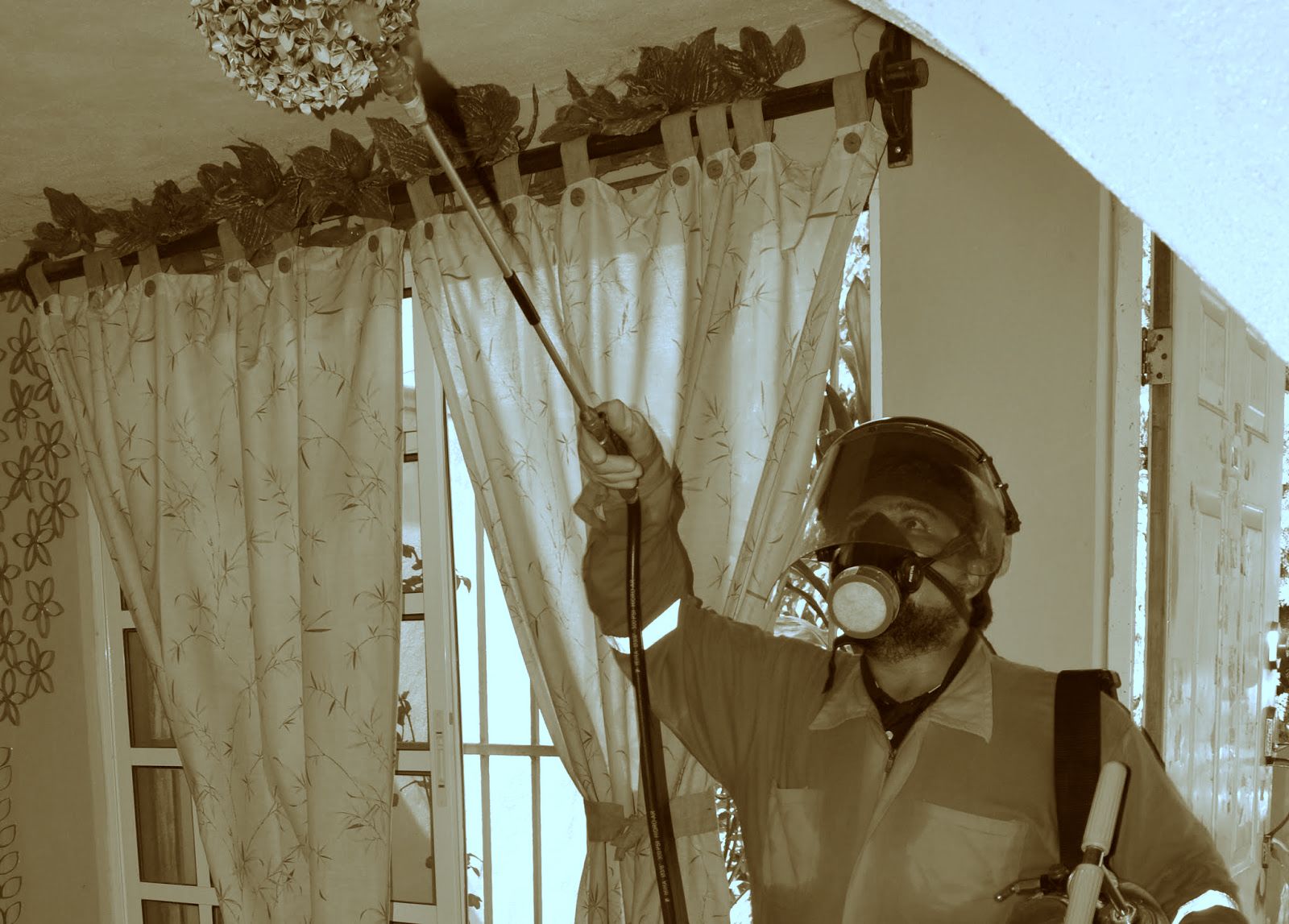A technician treats a home with insectide.
