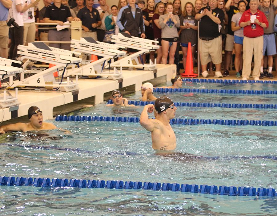 Andrew Wilson celebrates record 100-meter breaststroke win at 2017 NCAA Division III swimming championships.
