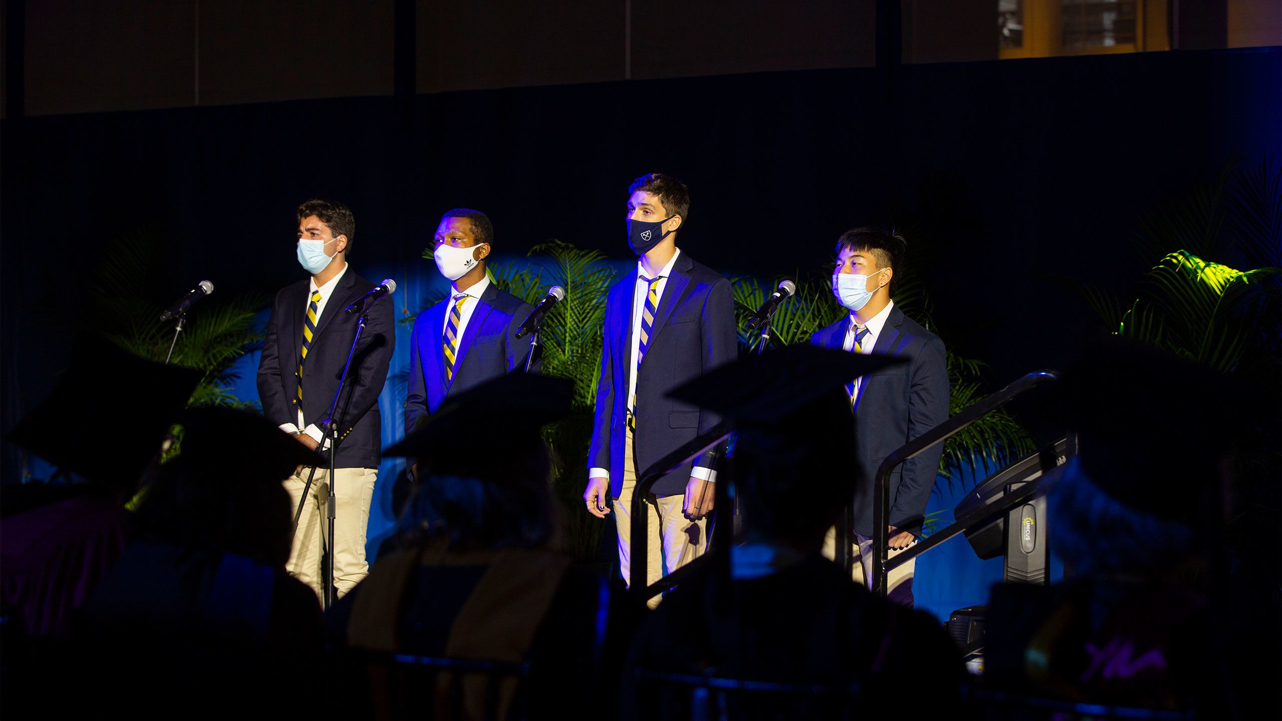 Emory students in masks sing the alma mater