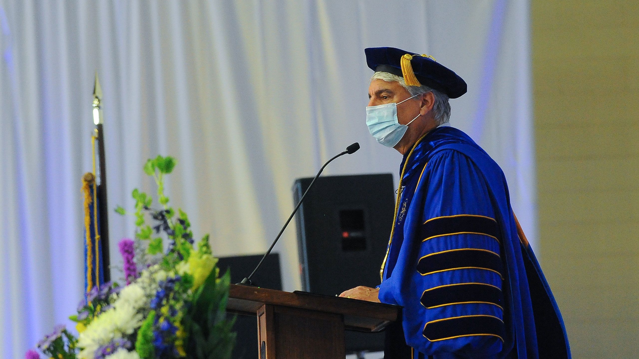 A side view of President Gregory L. Fenves at the podium
