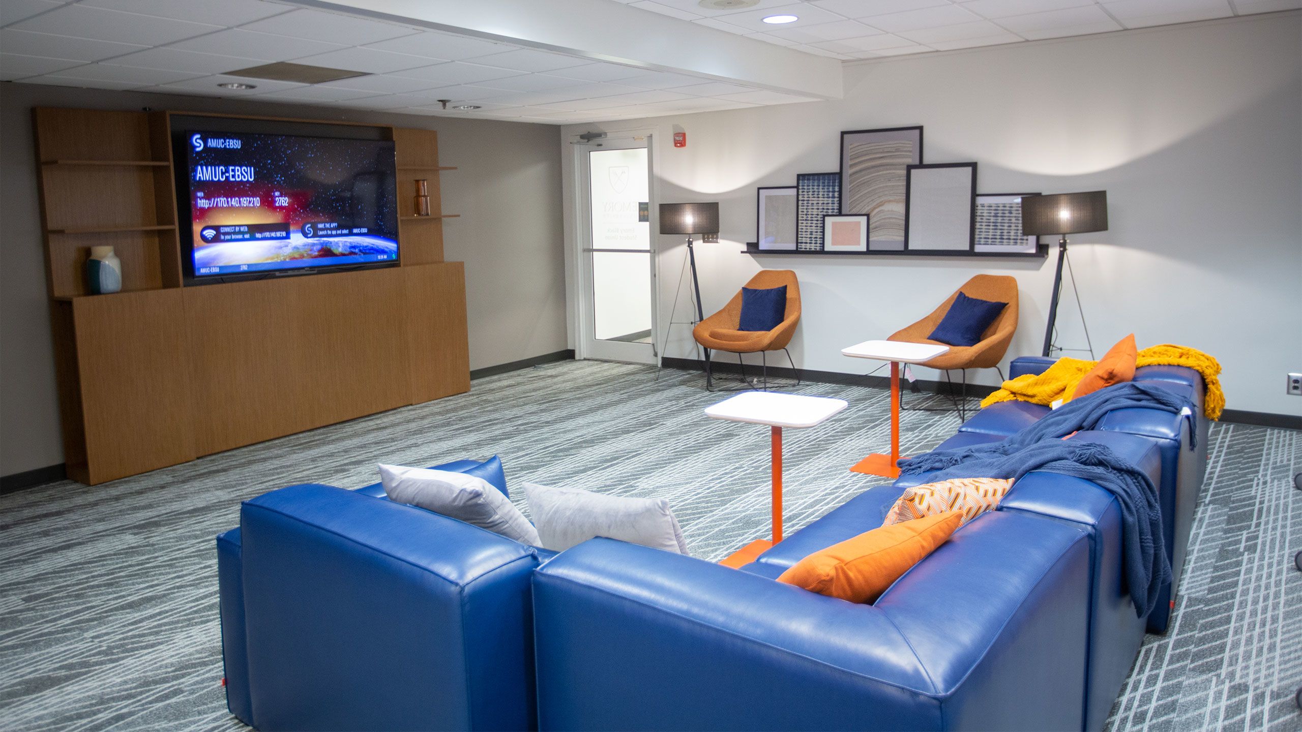 A television, couch and art are visible in the Emory Black Student Union