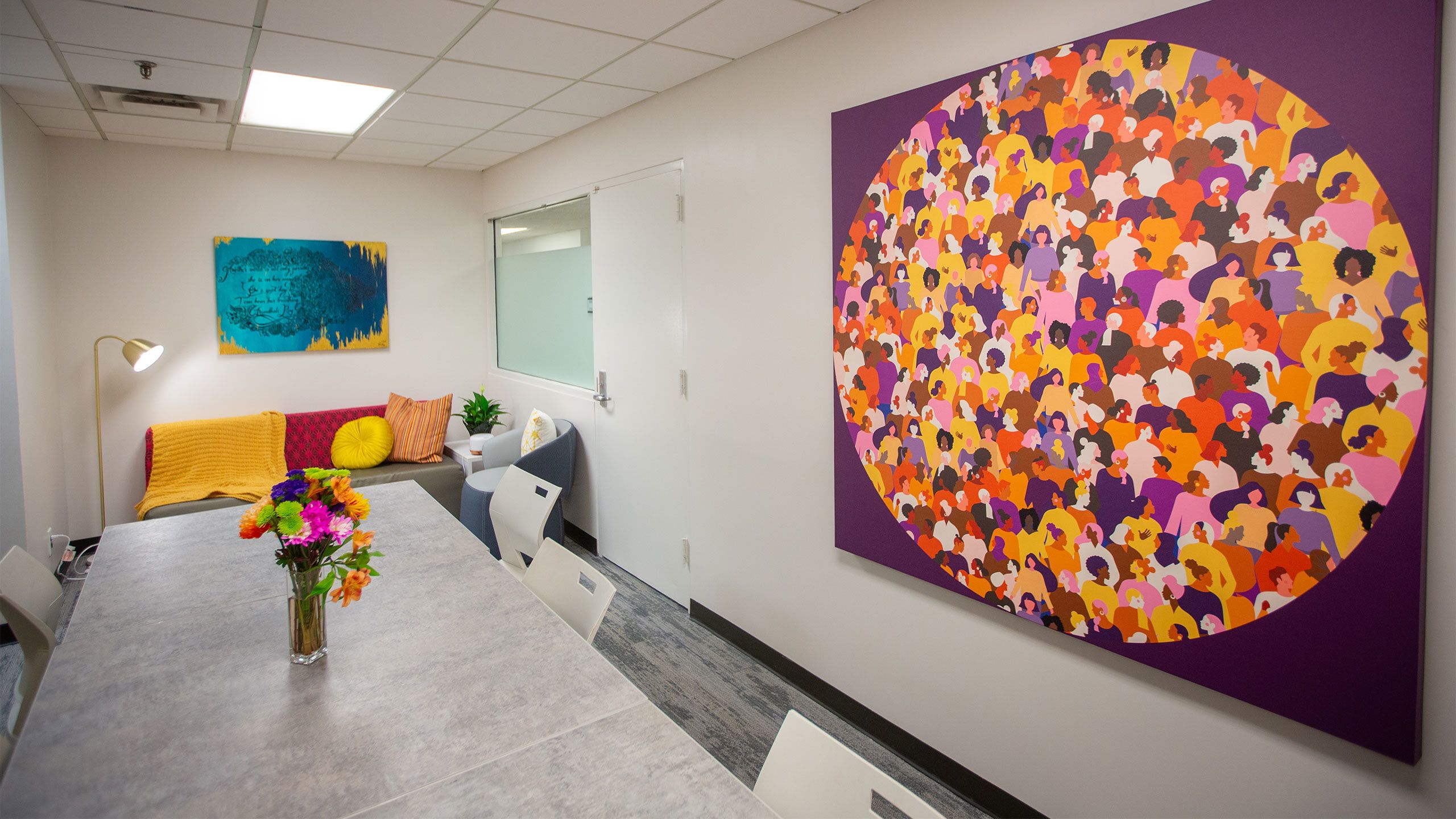 A large poster shows a circle of diverse women in the Center for Women