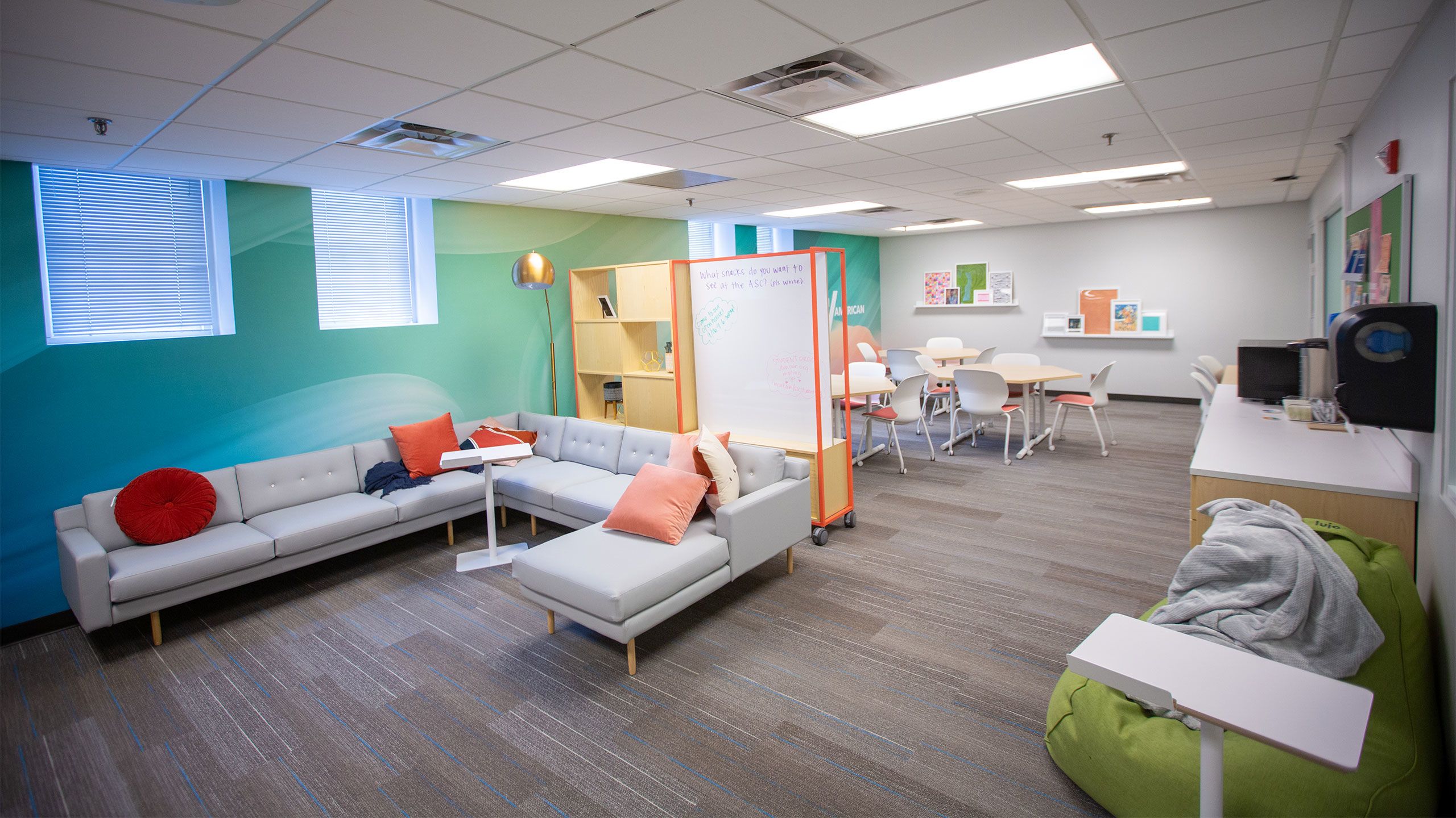 A sectional couch and tables are shown in the Asian Student Center