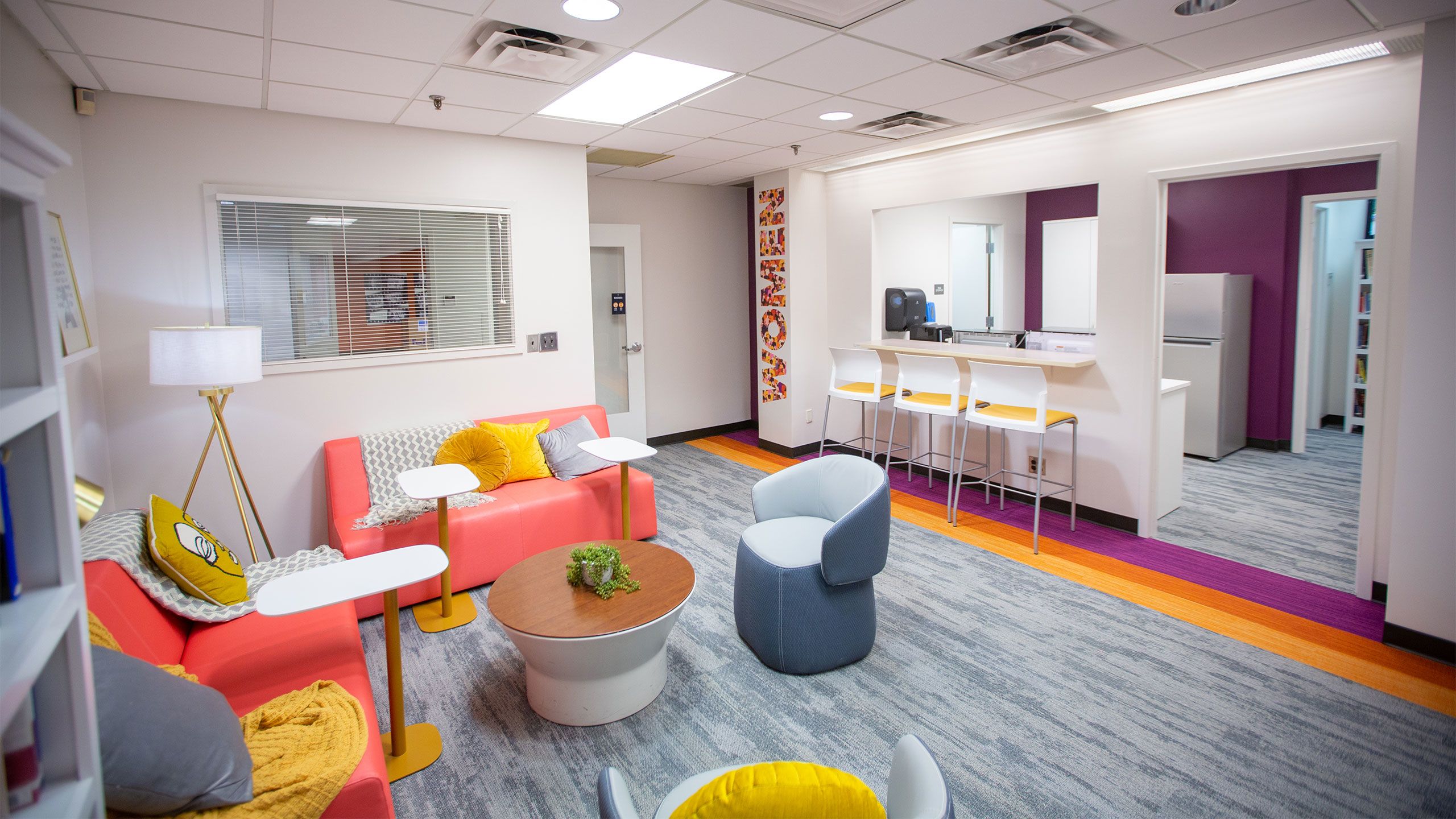 Sofas and a counter with stools can be seen in the Center for Women