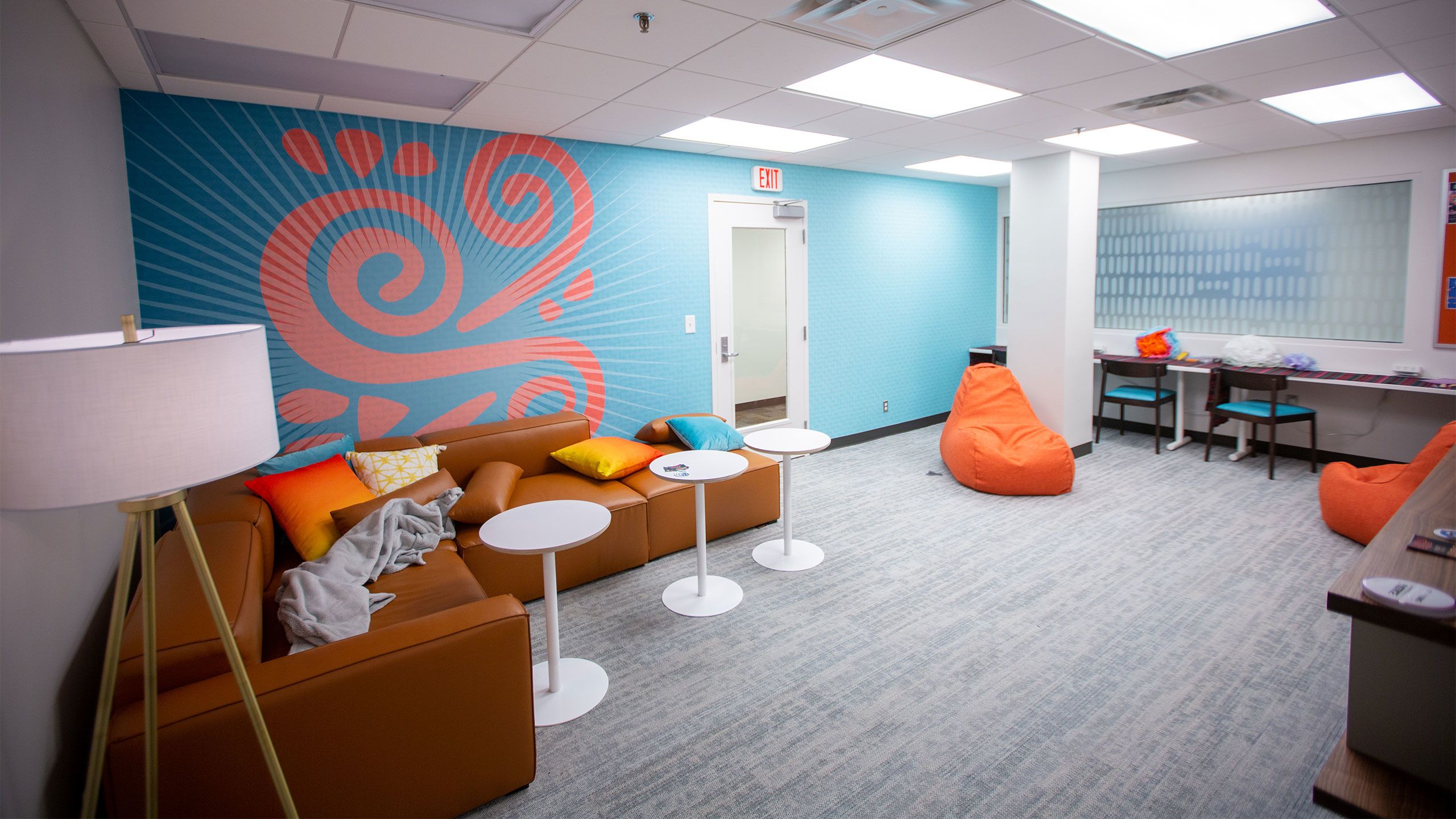 Couches with small tables a bean bag and desks in Centro Latinx