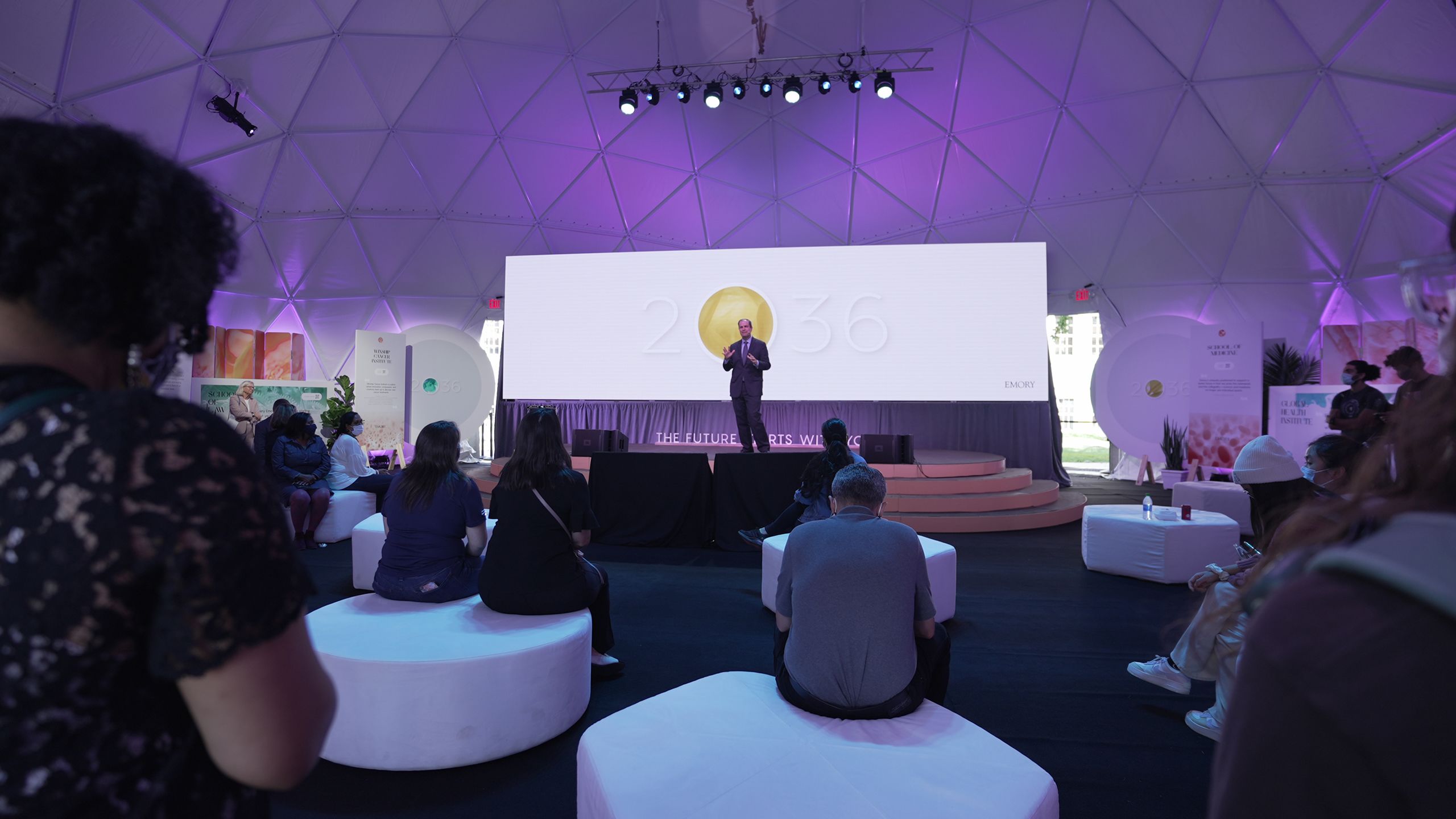 A person speaks on the stage in the Podium dome