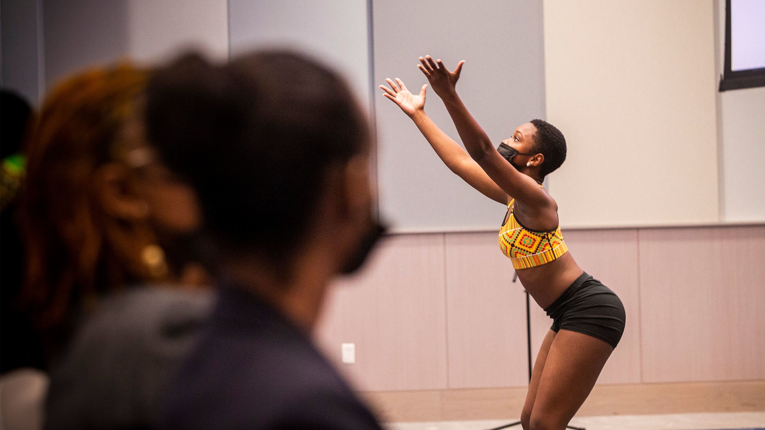 A student dances at the opening of the "In the Wake of Slavery and Dispossession" symposium