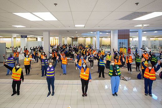 Volunteers wearing safety vests wave inside a former Kohl's department store