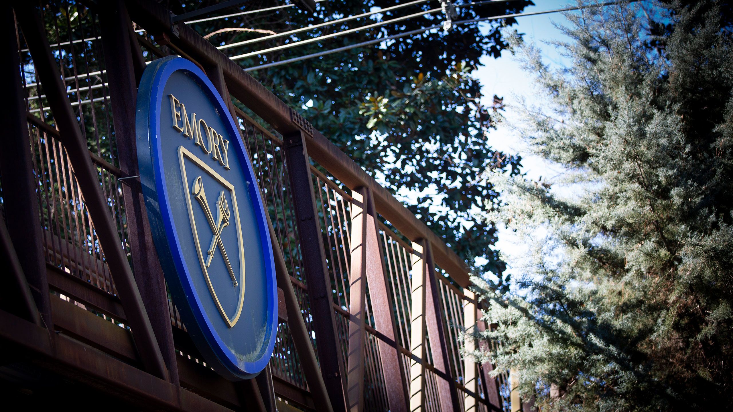 A close up of the Emory sign on the bridge across Houston Mill Road