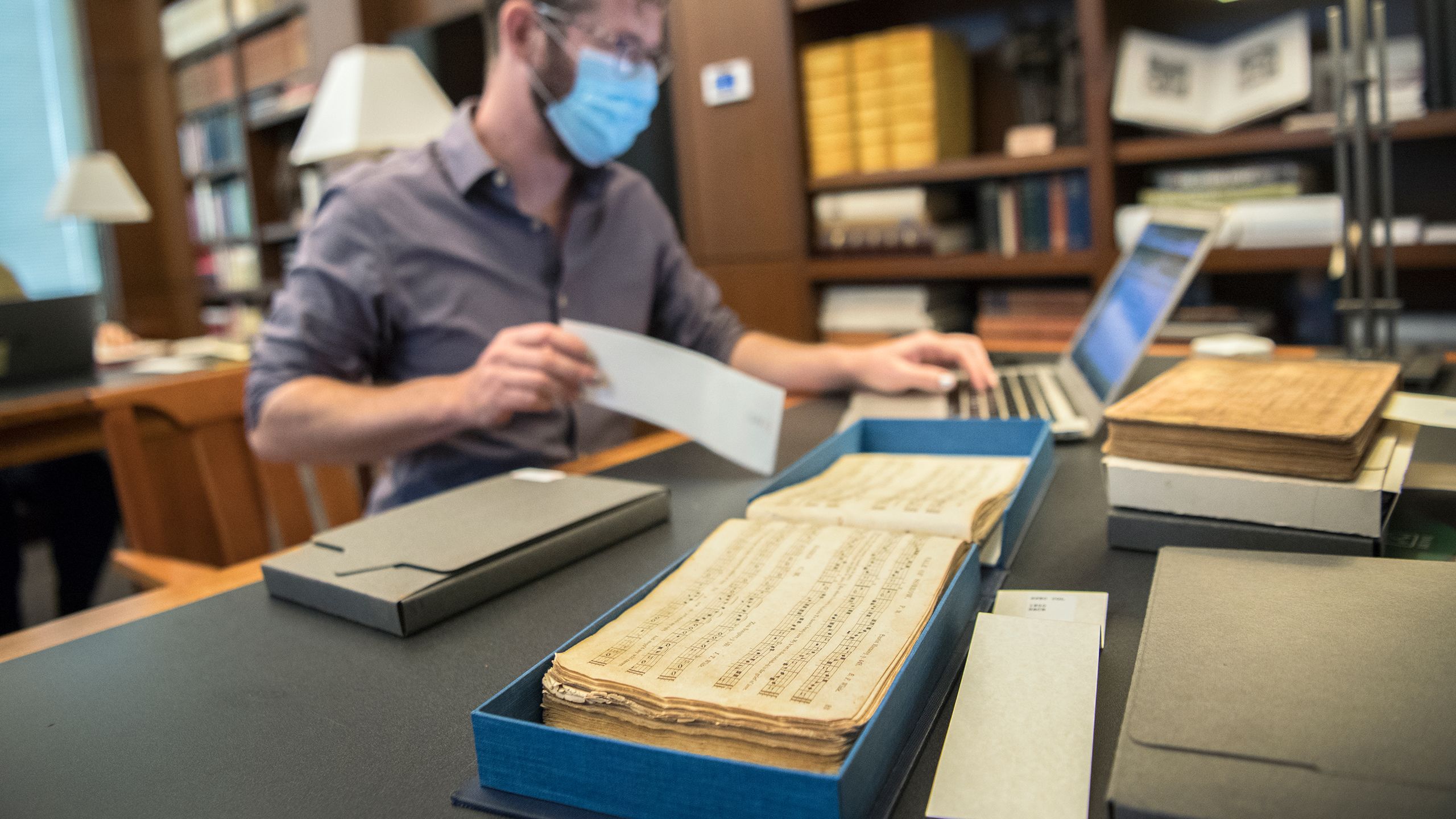 Jesse Karlsberg with one of the songbooks in the library