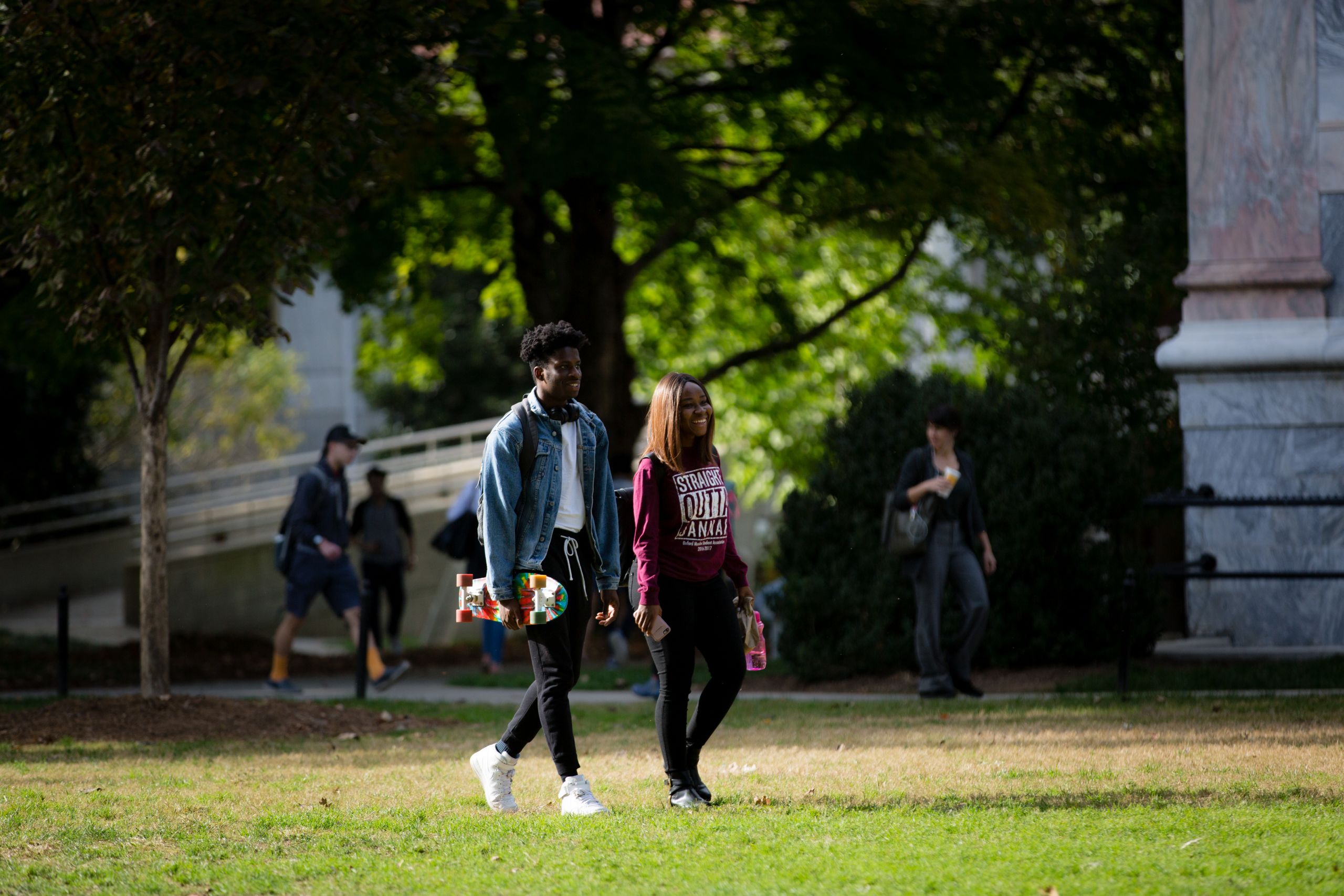 Two students walking across campus