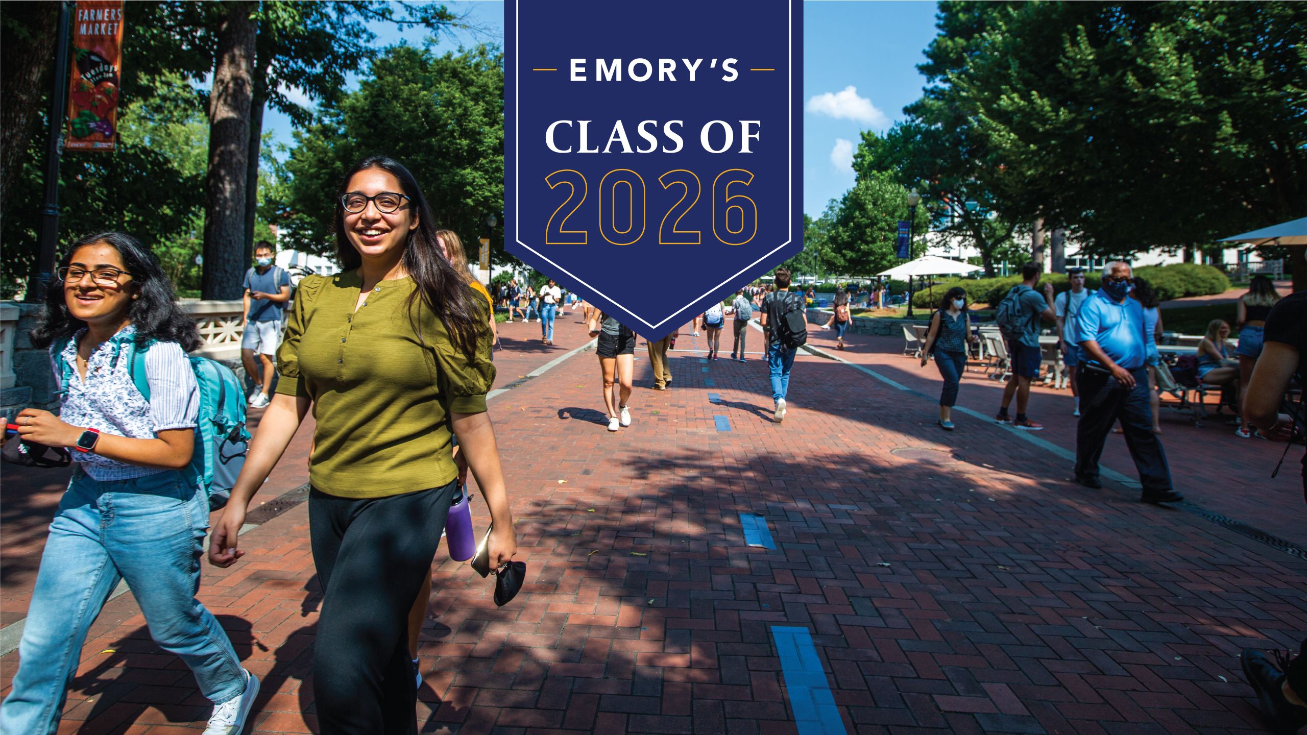 Emory's Class of 2025 with background photo of two students walking on a sidewalk