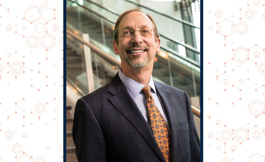 a portrait of Jon Lewin standing on the stairs in the new emory hospital tower.