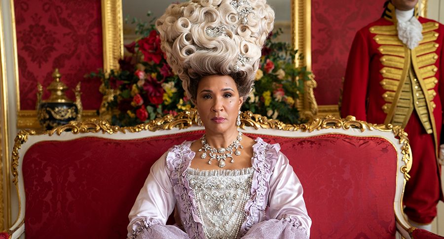 Van Dusen wrote Queen Charlotte into the series, though she does not appear in the novels. Guyanese-British actress and singer, Golda Rosheuvel, portrays the imposing monarch.