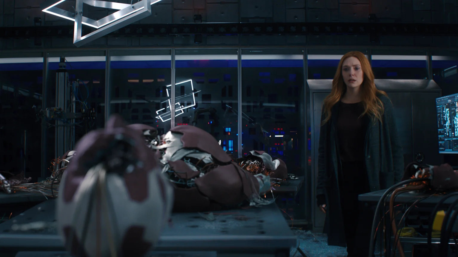 From upcoming movie WandVision: Wanda Maximoff is looking at the synthezoid Vision, who is stretched out on table and obviously damaged.