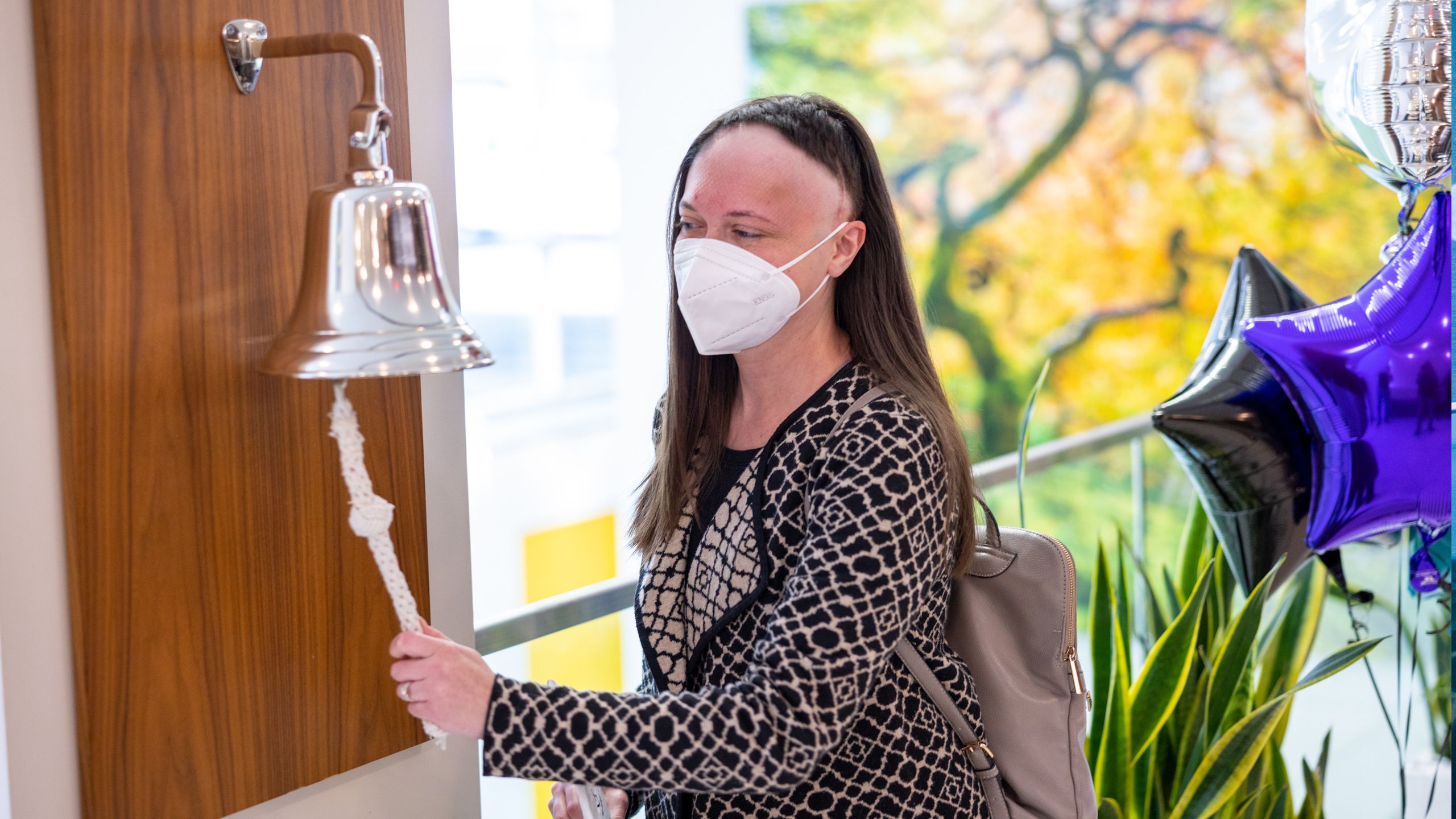 Megan Smith ringing cancer treatment event bell