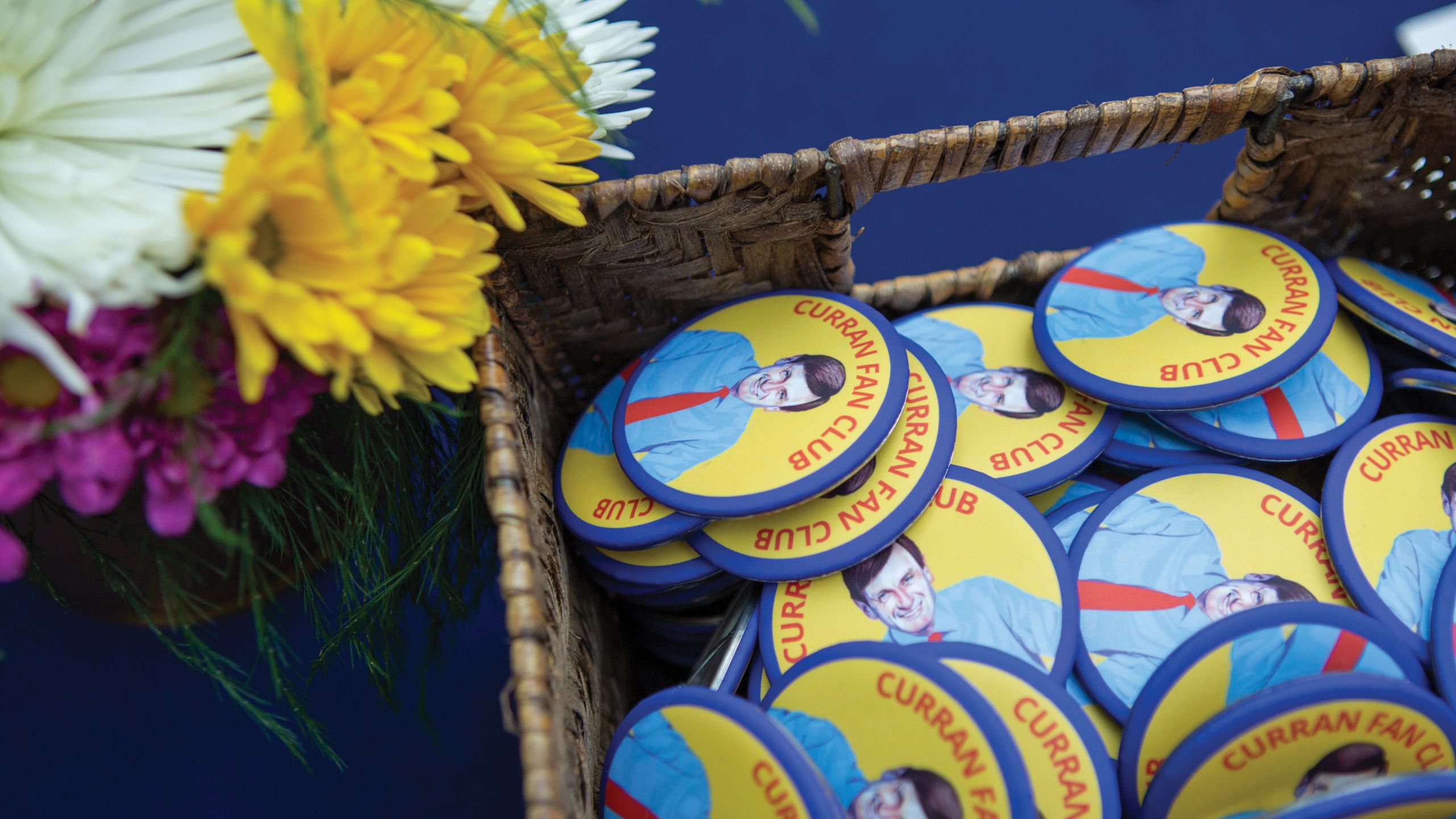 A basket of Dean Curran Fan Club buttons