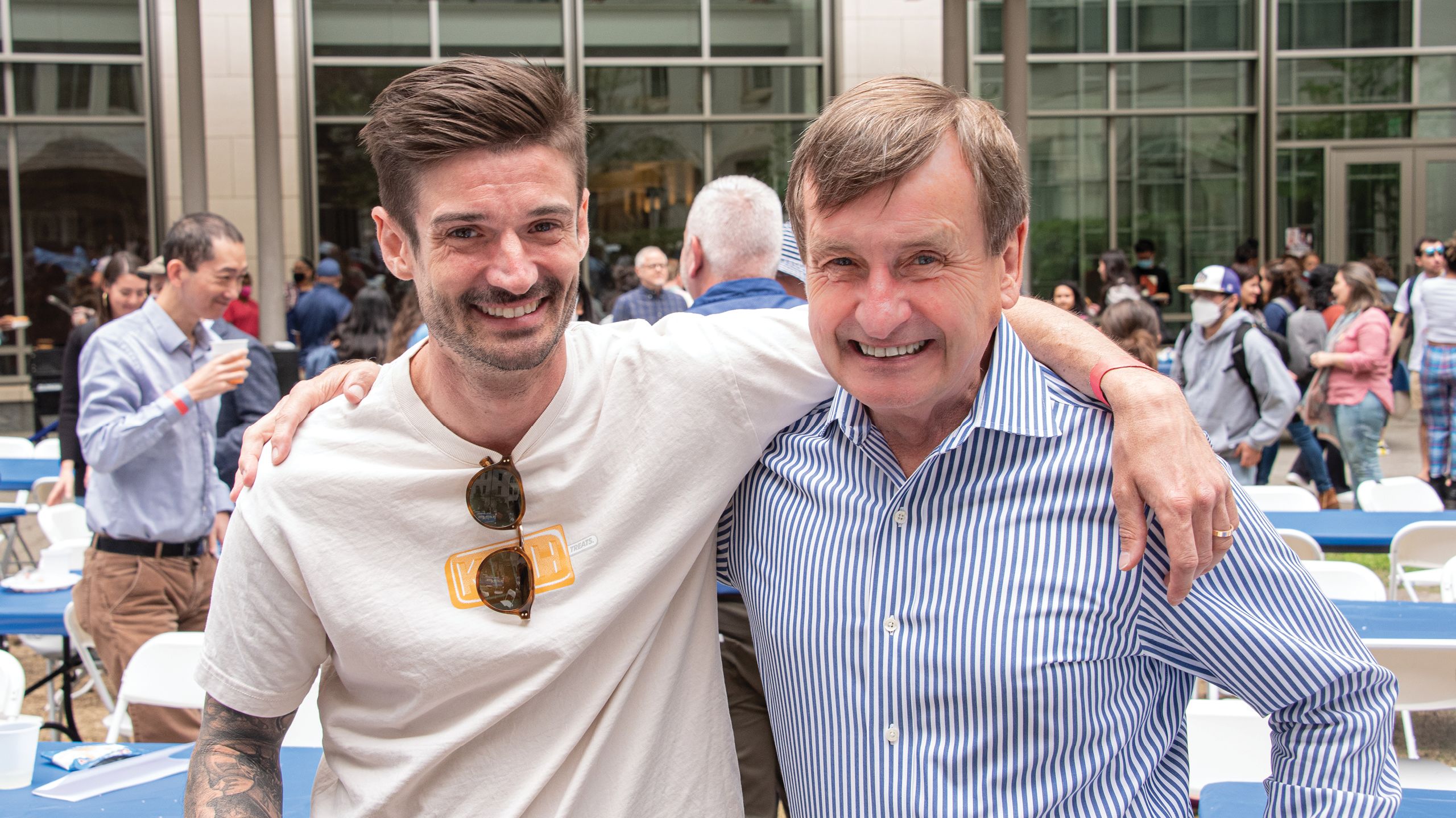 Two men with their arms around each other.