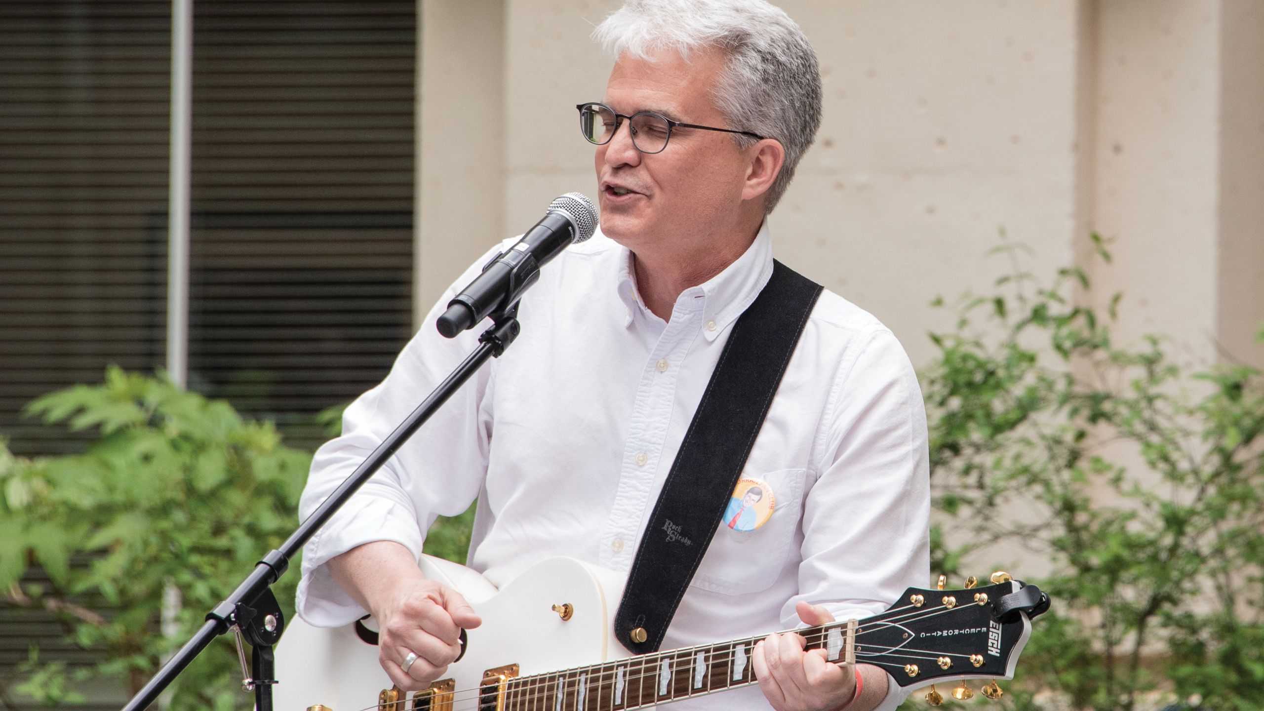 A man plays the guitar and sings.
