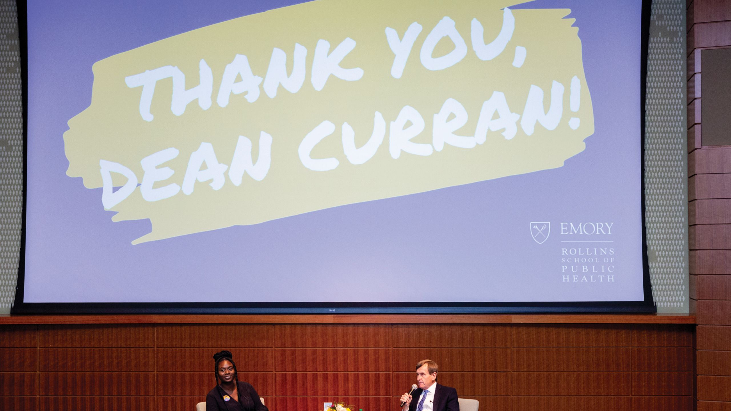 A large screen has the words Thank you, Dean Curran