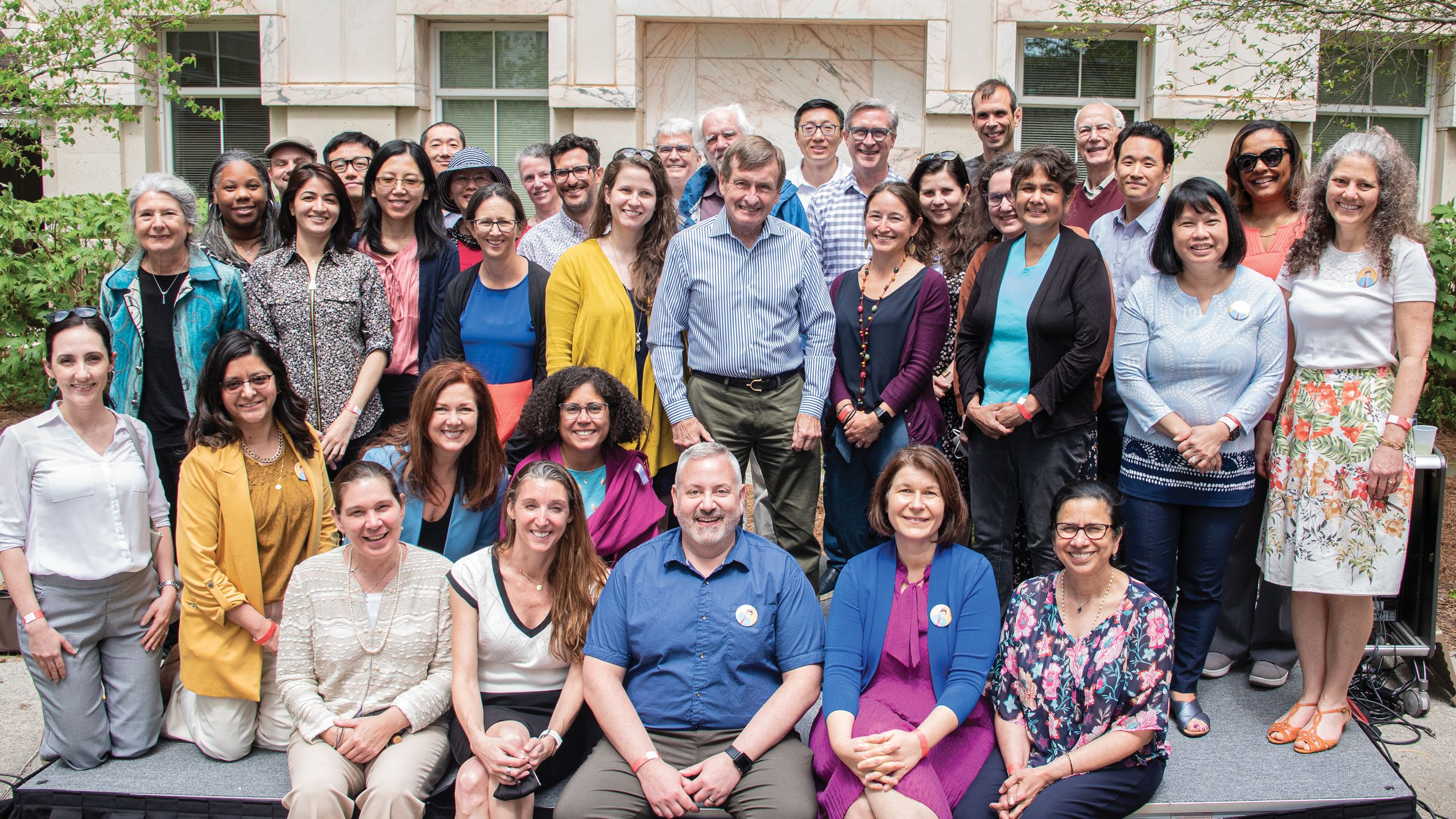 A large crowd of people smile and pose.