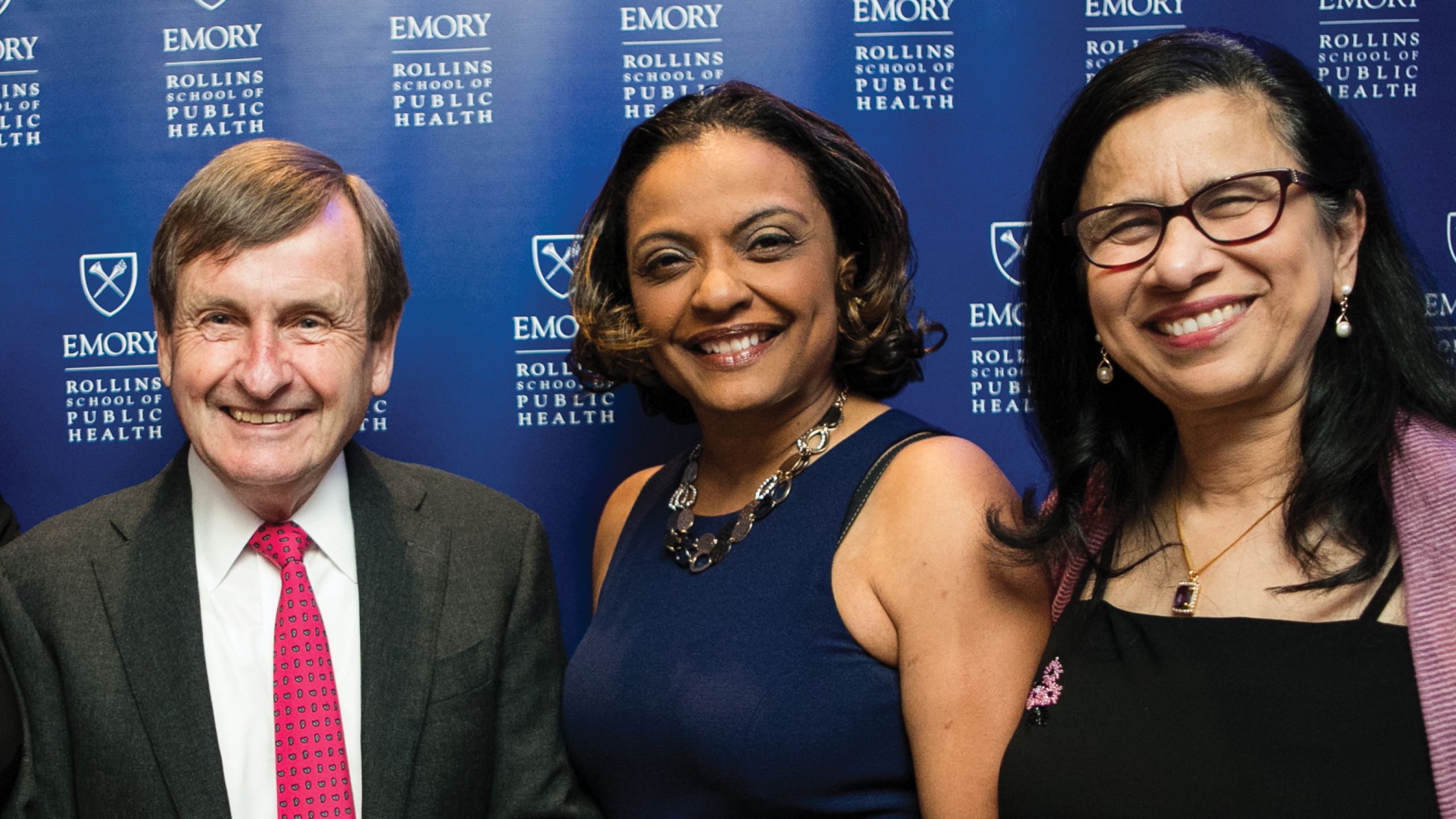 Two women and one man pose