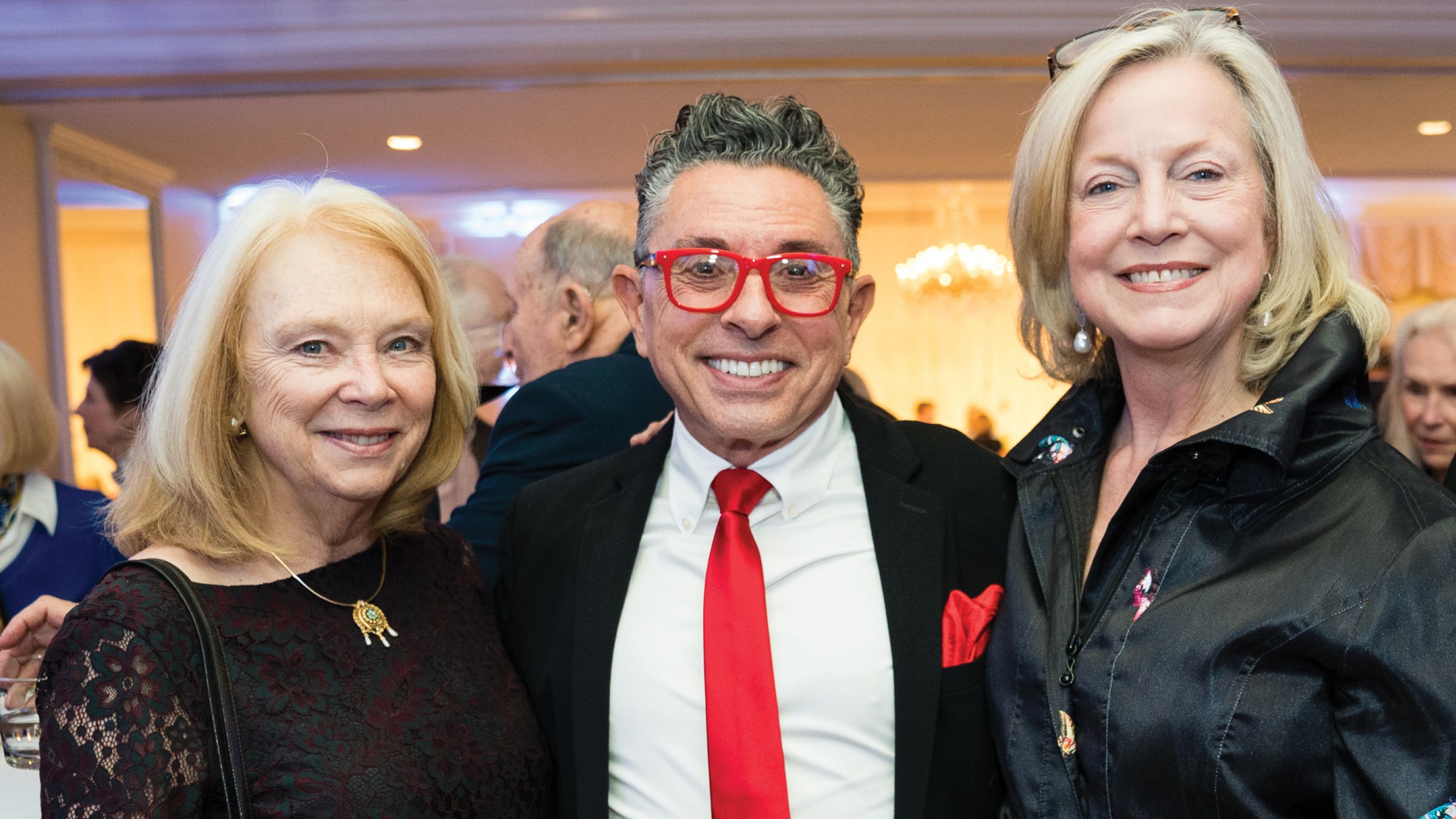 Two women and one man pose